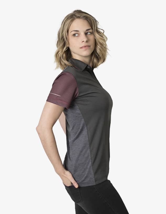 A polo shirt featuring grey and maroon panels, with a logo present on the garment.