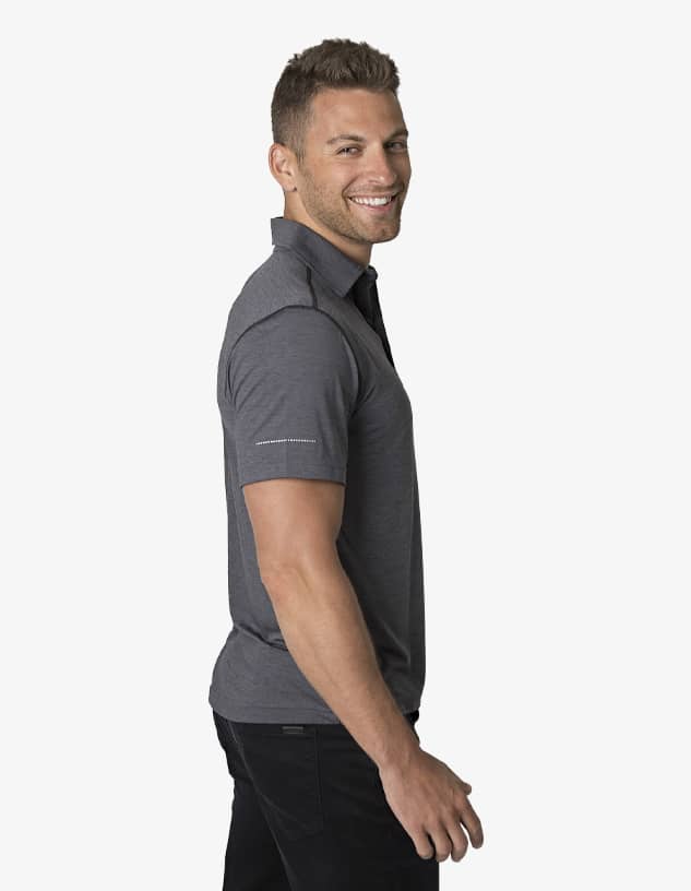A grey polo shirt is displayed on a smiling male model in profile, showcasing a branded detail on the sleeve.