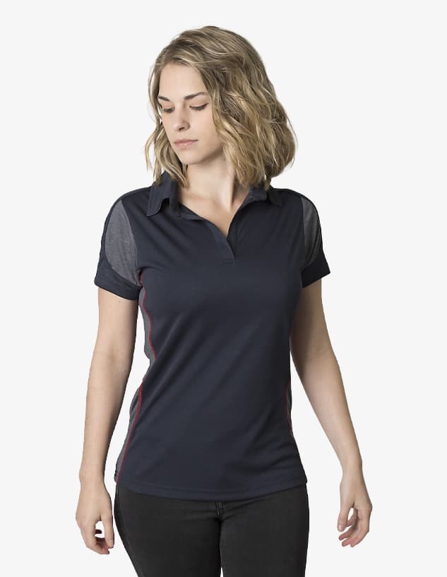 A women's polo shirt in navy with contrasting grey panels and a collar. The shirt features a logo on one side.
