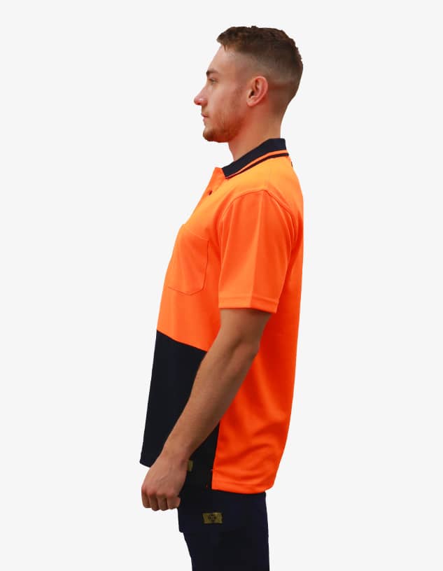 A bright orange and navy work polo shirt features a pocket and a brand logo, shown on a model from the side.