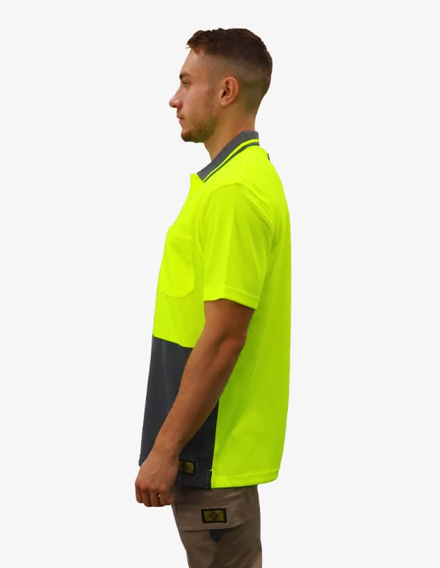 A high-visibility work polo shirt in fluorescent yellow and navy, featuring a pocket and branding.