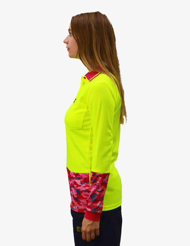 A women's polo shirt in bright yellow with pink camouflage sleeves. It features a logo on the front.