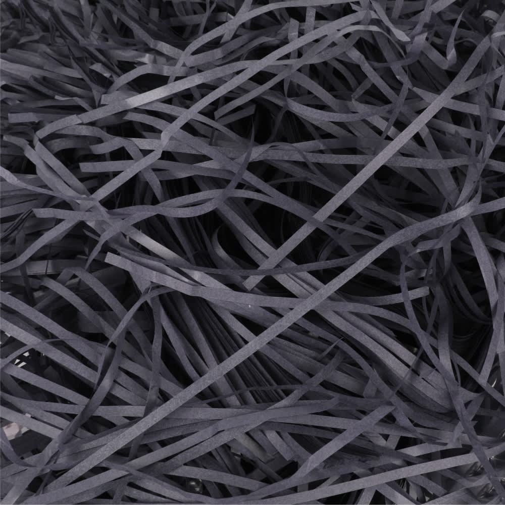 A pile of thin, dark grey paper strands, creating a textured, shredded appearance in a close-up view.