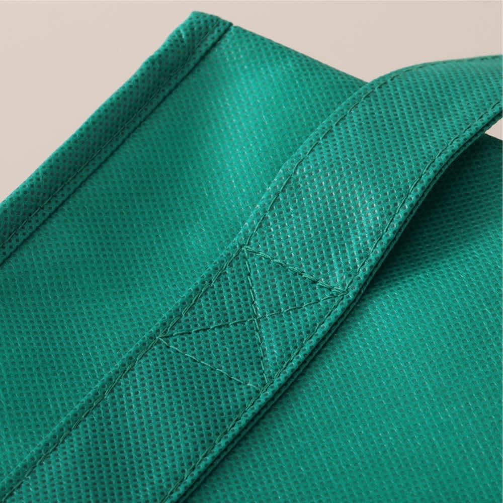 A green tote bag with a textured surface and reinforced straps. Features stitching detail along the handle.