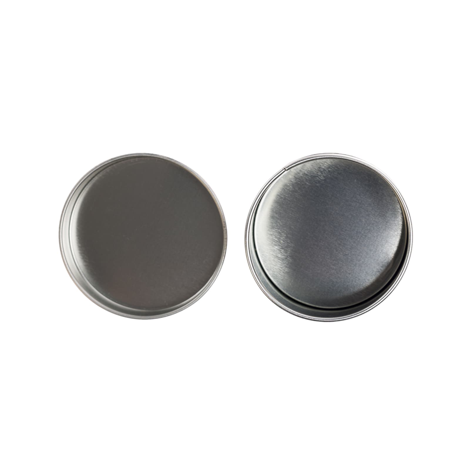 Two silver round tins with smooth metallic surfaces, featuring a polished finish.