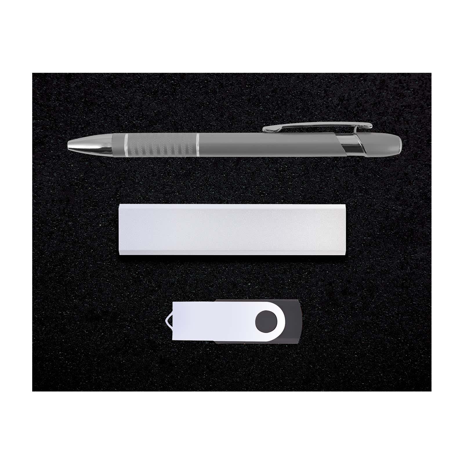 A silver pen, USB drive, and a sleek metallic note holder arranged on a black background.