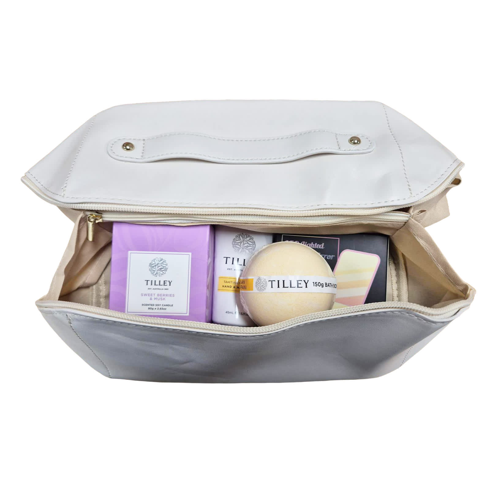 A cream-coloured bag contains various Tilley products, including soap and skincare items in purple and white packaging.