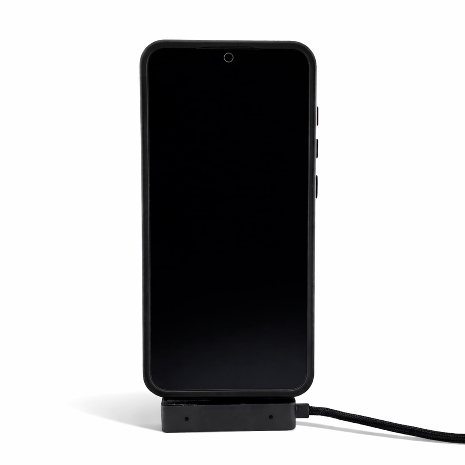 A black phone is displayed on a charger, connected by a charging cable. The charger has a sleek design.