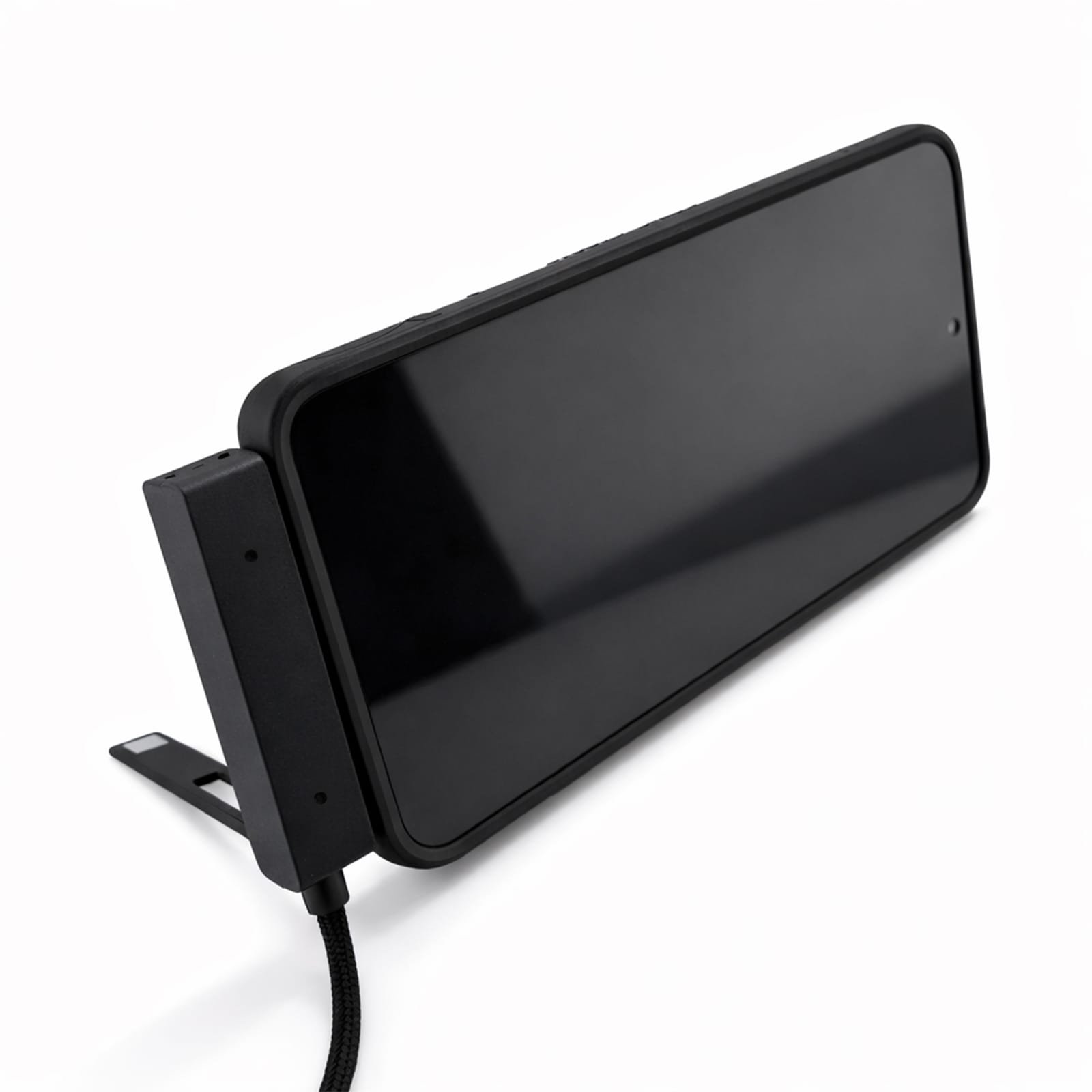 A black charging cable is positioned next to a sleek, black electronic device with a large screen.