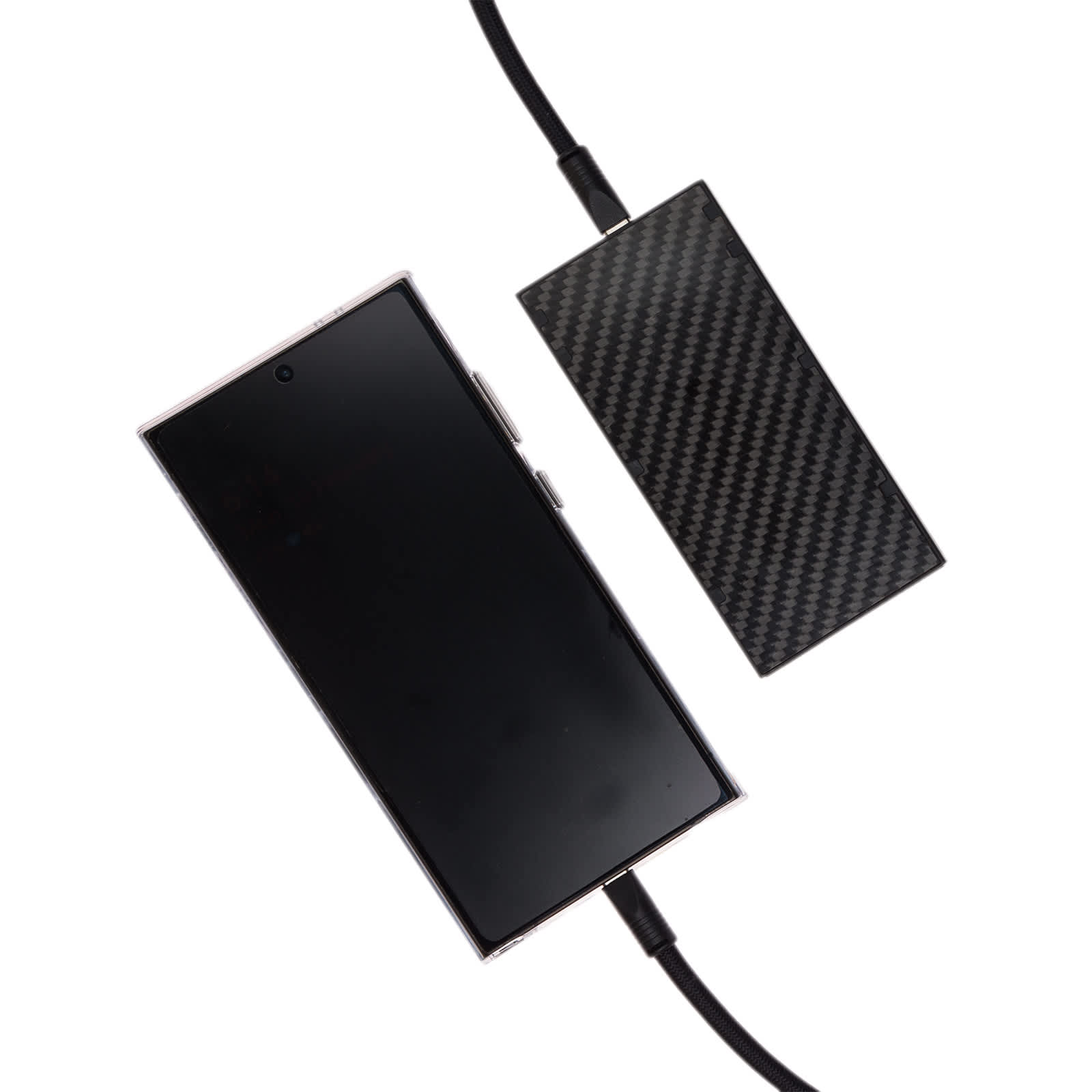 A smartphone connected to a charging cable with a sleek, carbon fiber design power bank.