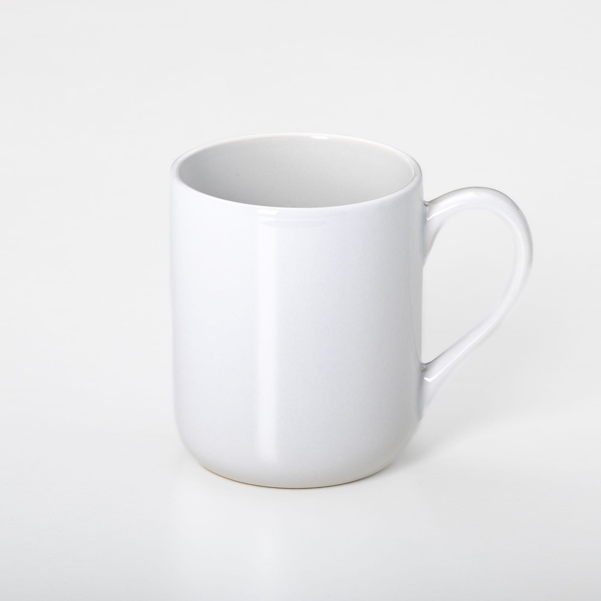 A white coffee mug with a smooth finish and a curved handle. Features a simple design and includes a branding logo.