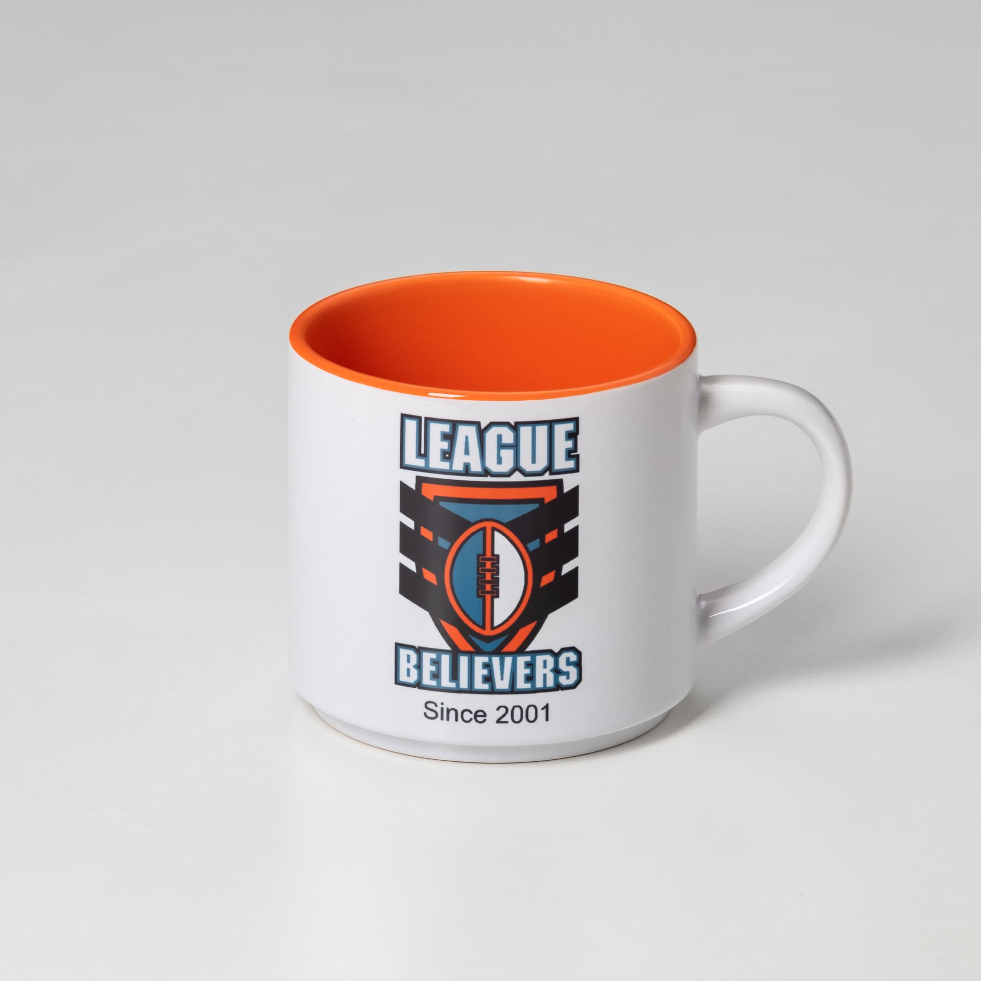A coffee mug with a white exterior and orange interior, featuring a logo on one side.