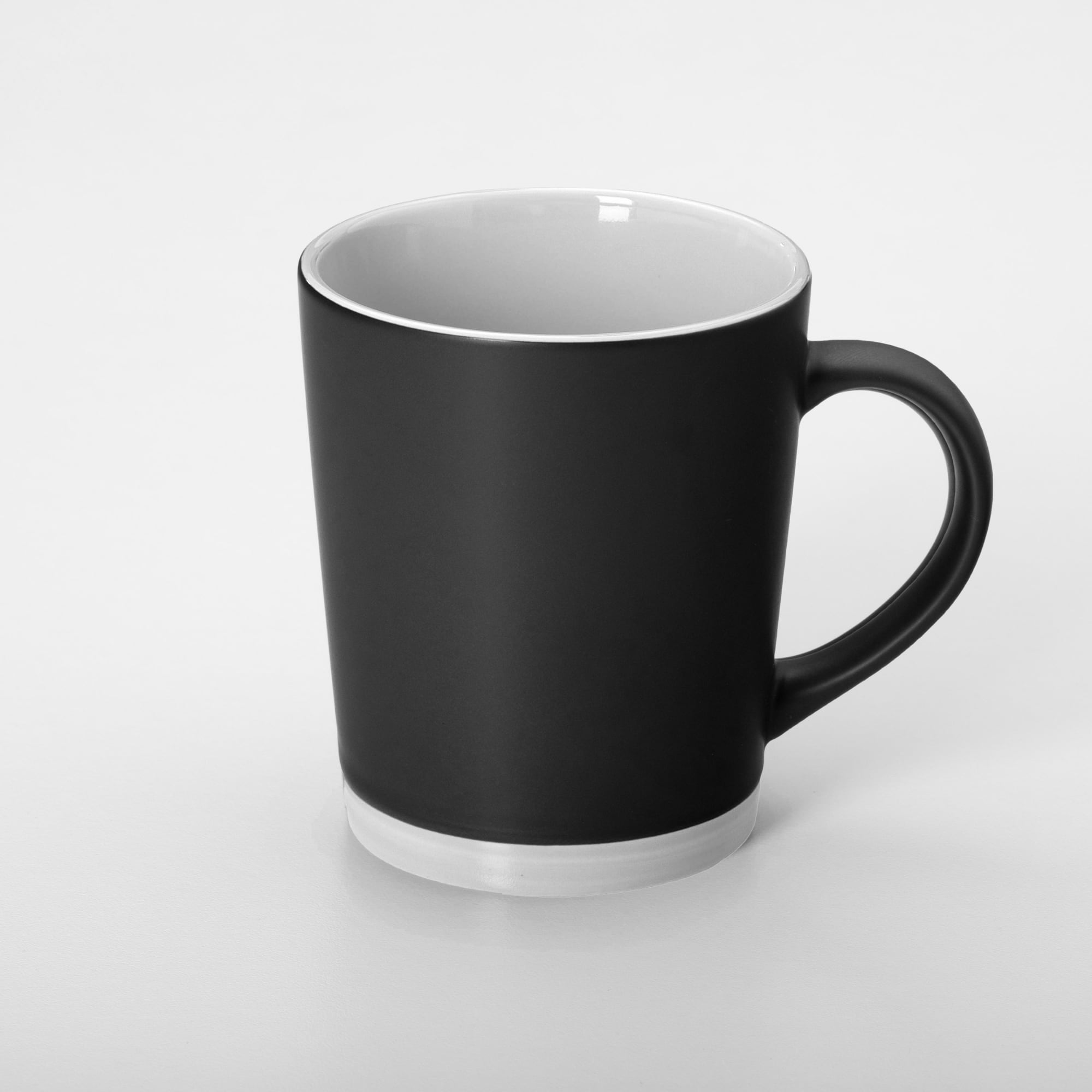 A coffee mug featuring a sleek black exterior with a white interior and base, complete with a handle.