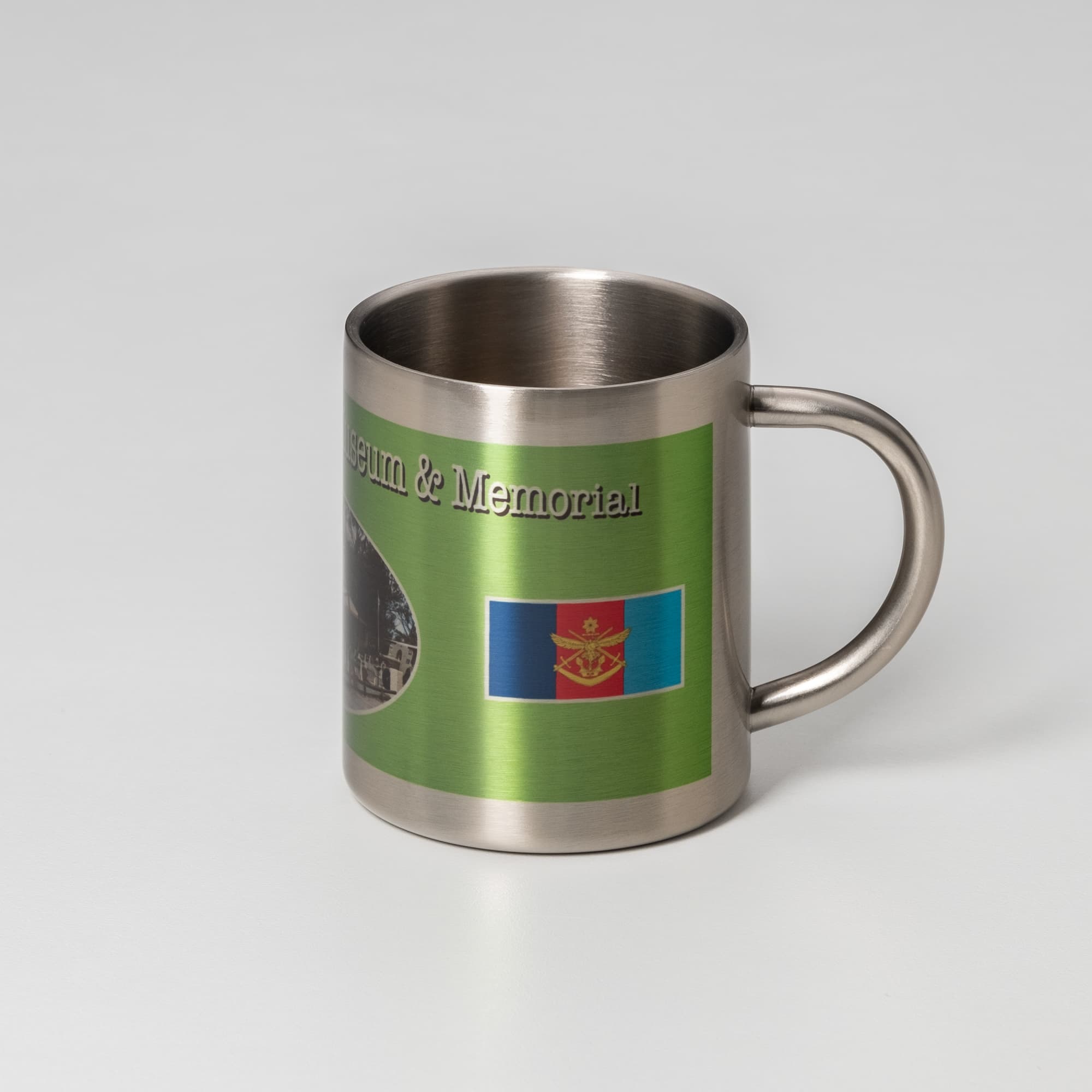 A stainless steel travel mug featuring a green design with images and a logo.