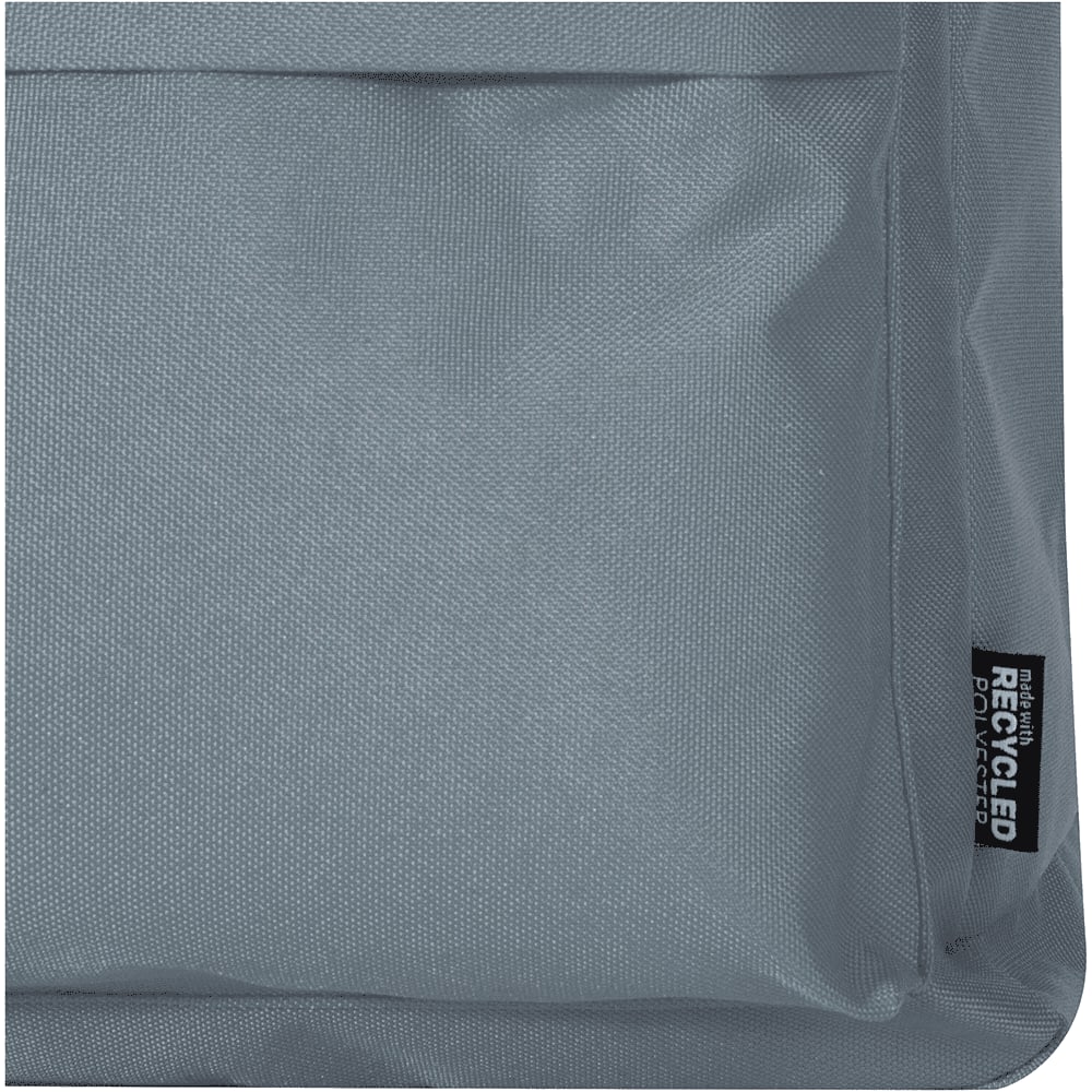 A grey fabric section of a laptop backpack featuring a logo and a textured surface.