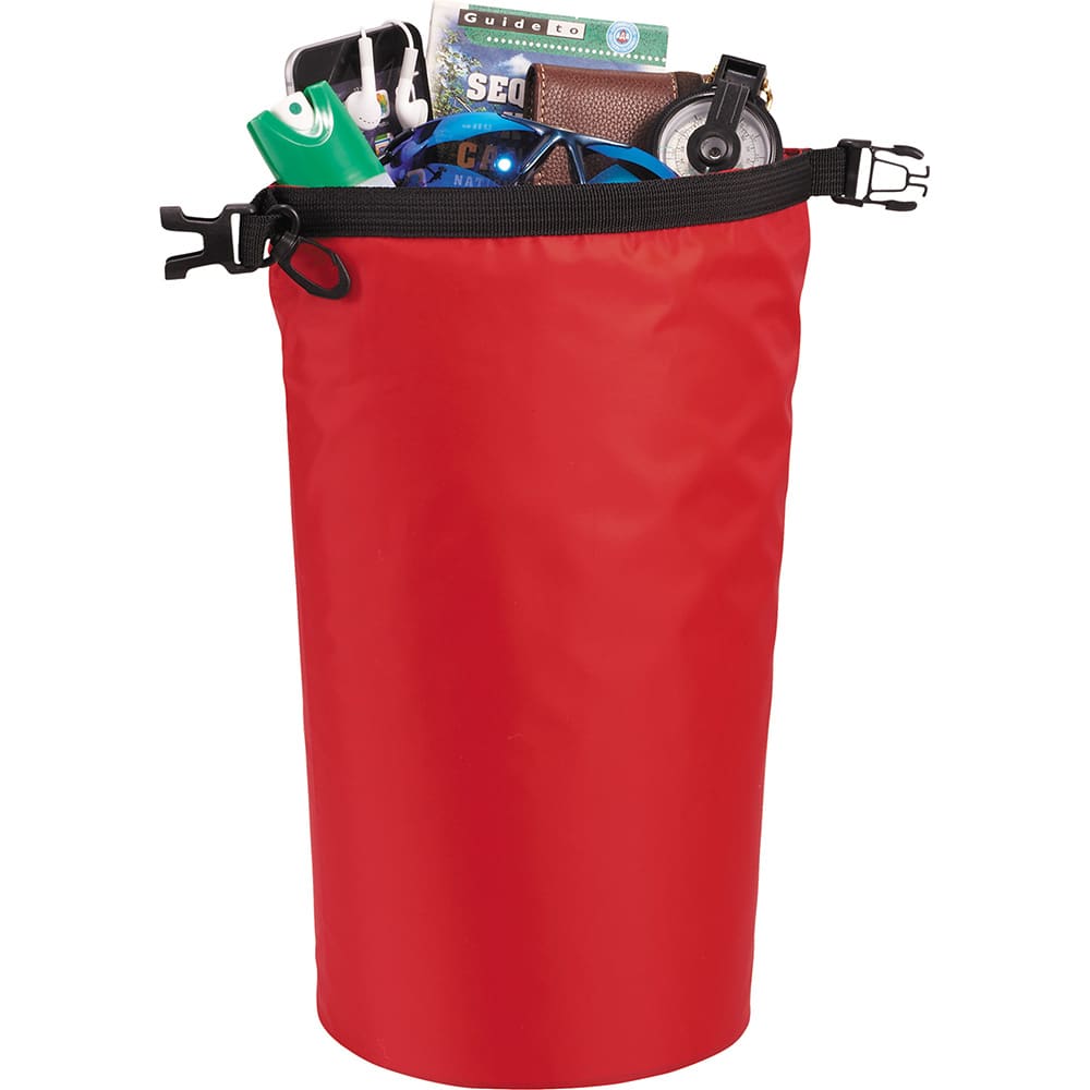 A red waterproof outdoor bag filled with assorted items, including a drink bottle, headphones, and a wallet.