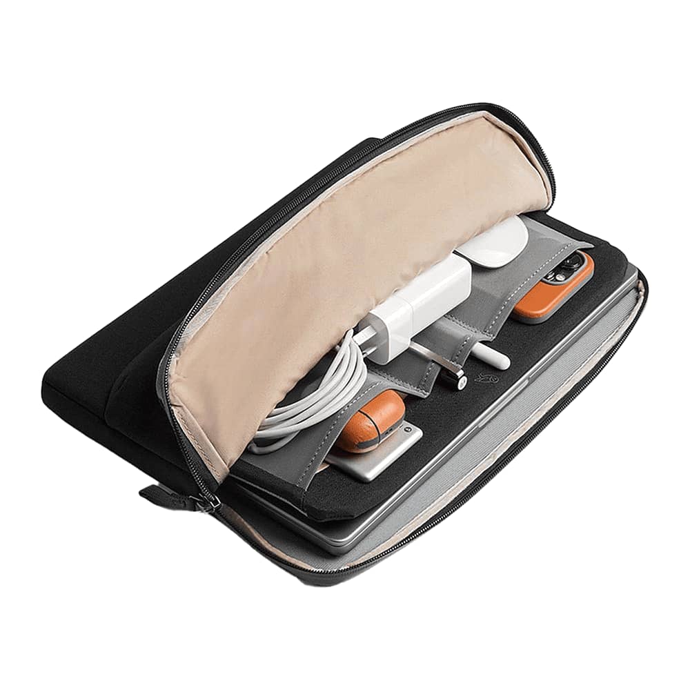 A black laptop caddy featuring a light interior, holding tech accessories, cables, and a laptop. It has a branded logo.