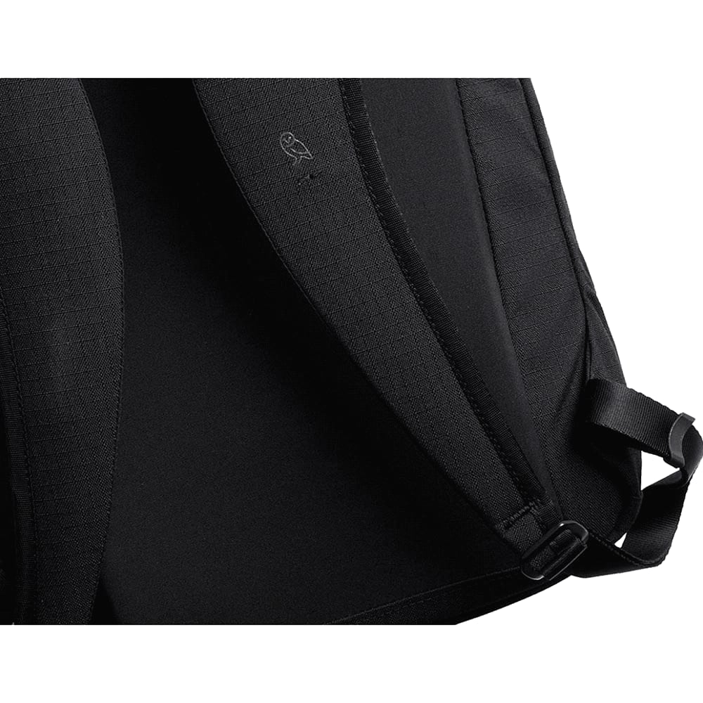 A black backpack interior featuring a textured lining and adjustable straps, with a logo on the inner fabric.
