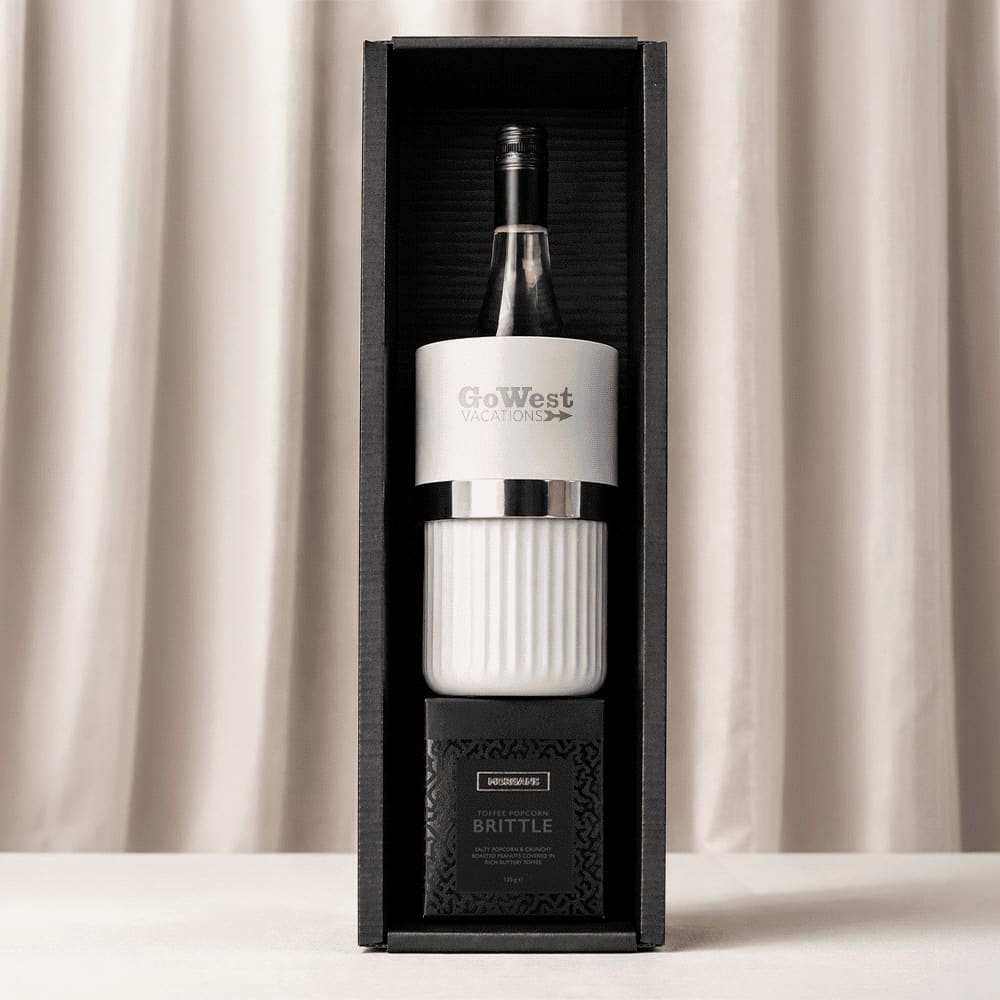 A wine bottle with a white and black cooler, placed in a stylish black and white gift box.