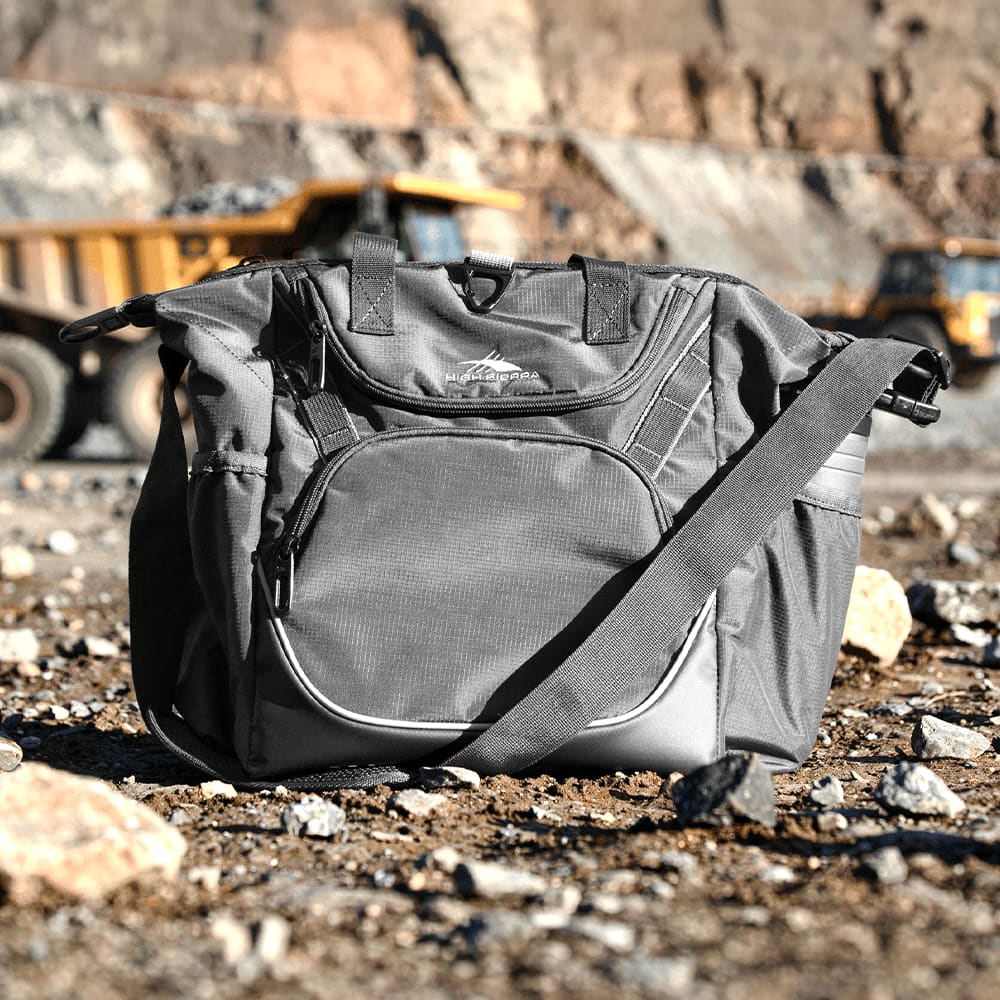 A grey cooler bag with a shoulder strap and multiple compartments, featuring a logo on the front.