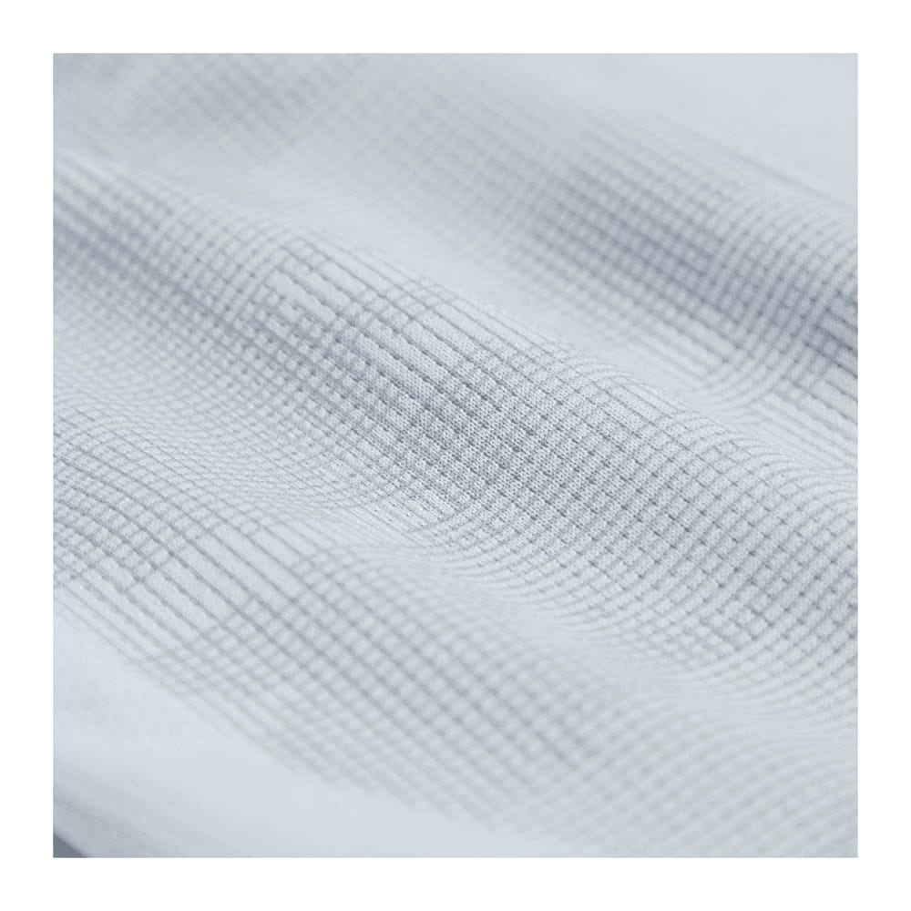 A textured close-up of fabric in a light grey hue, featuring a subtle grid pattern.