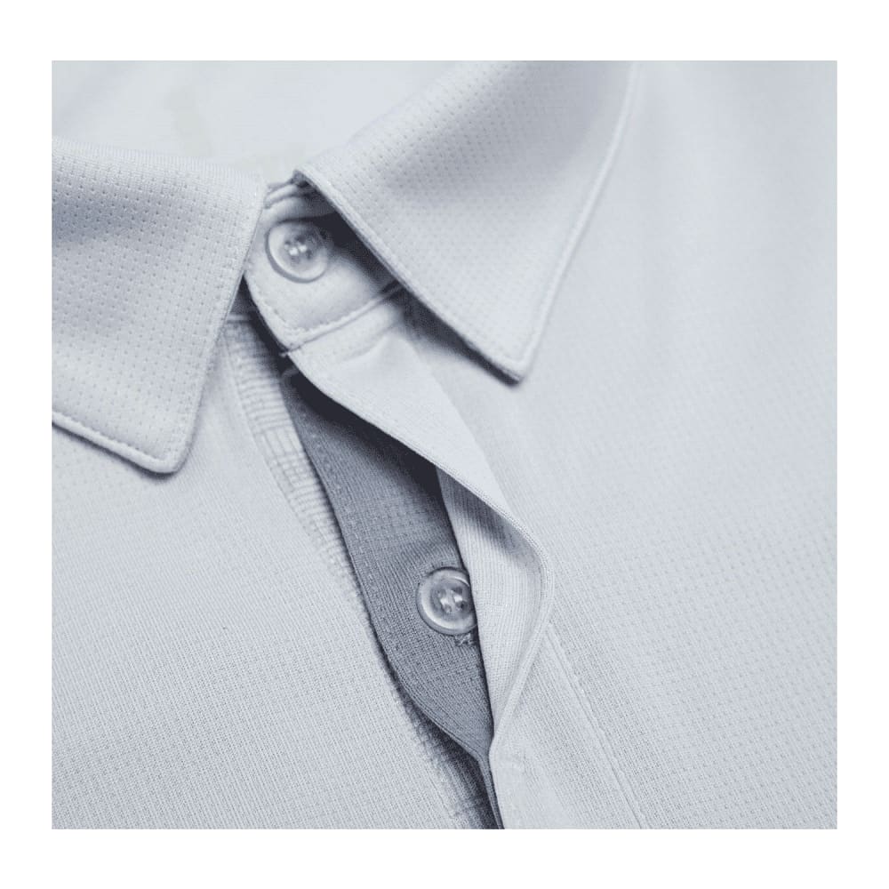 A light grey men's polo shirt with a collar and buttons, featuring a textured fabric and a logo.