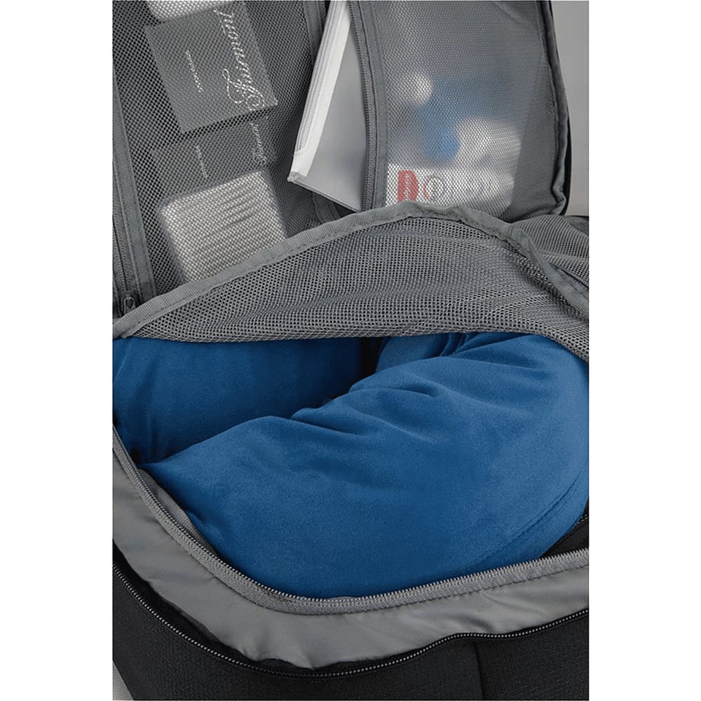 A travel backpack in grey with a blue neck pillow visible in an inner compartment, along with other items.
