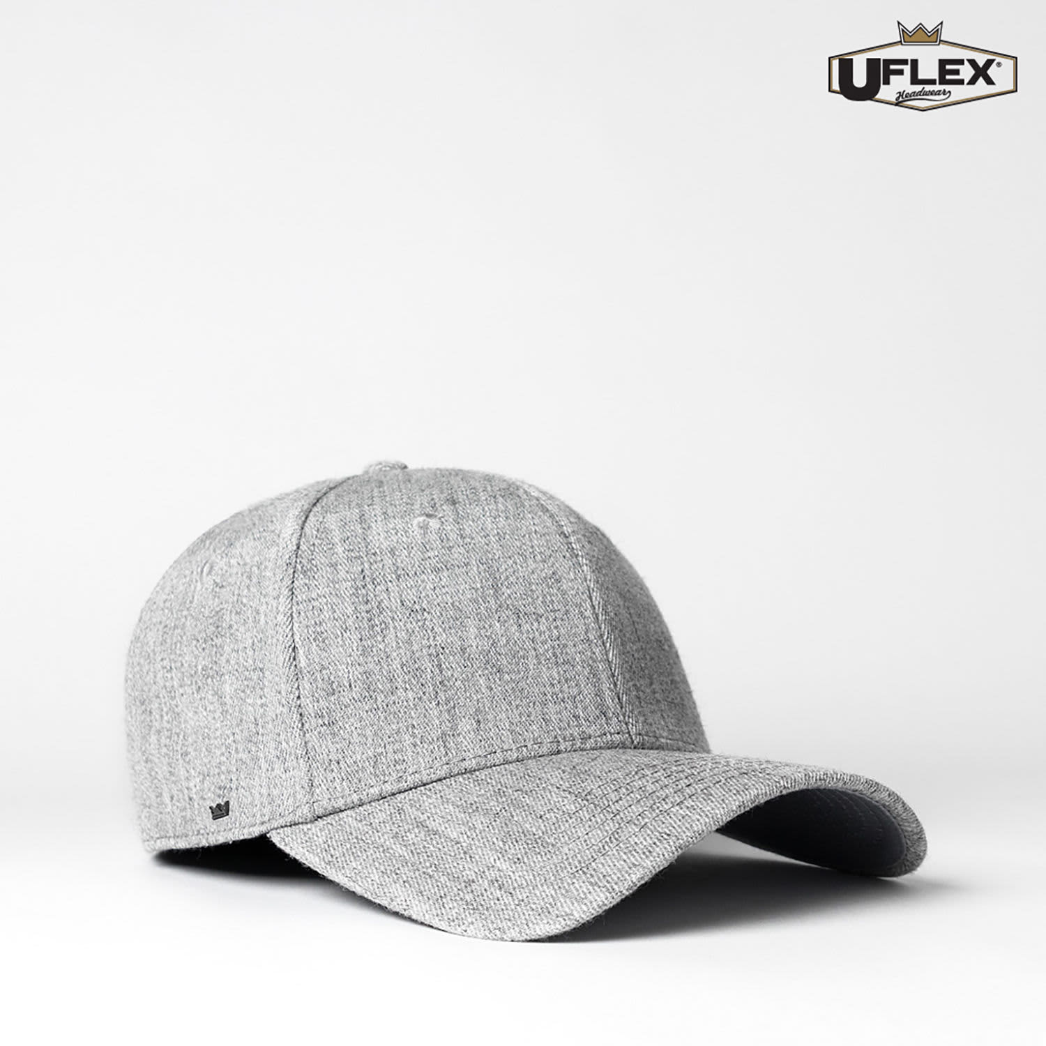 A grey fitted cap with a curved brim and a logo on the side, designed for adults.