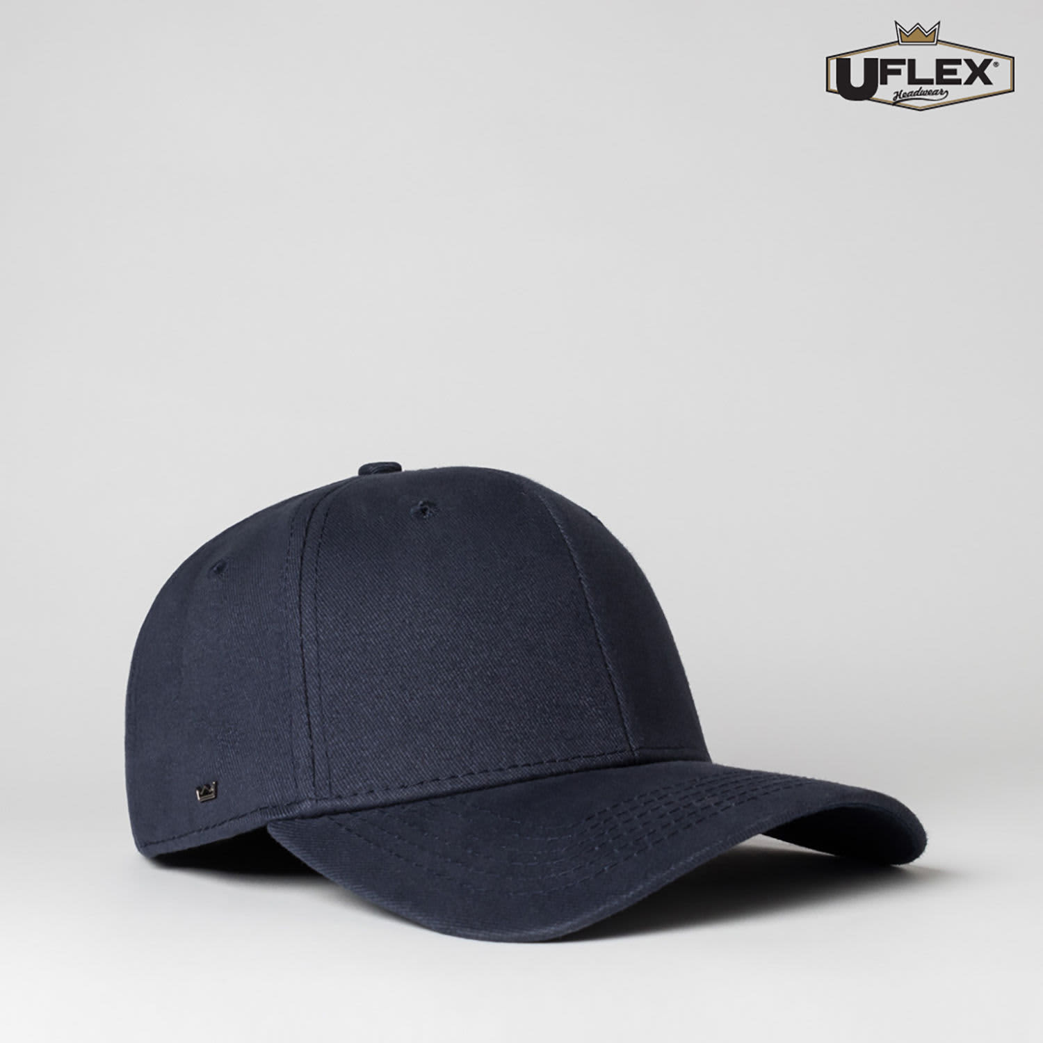 A navy blue fitted cap with six panels and a logo on the side.