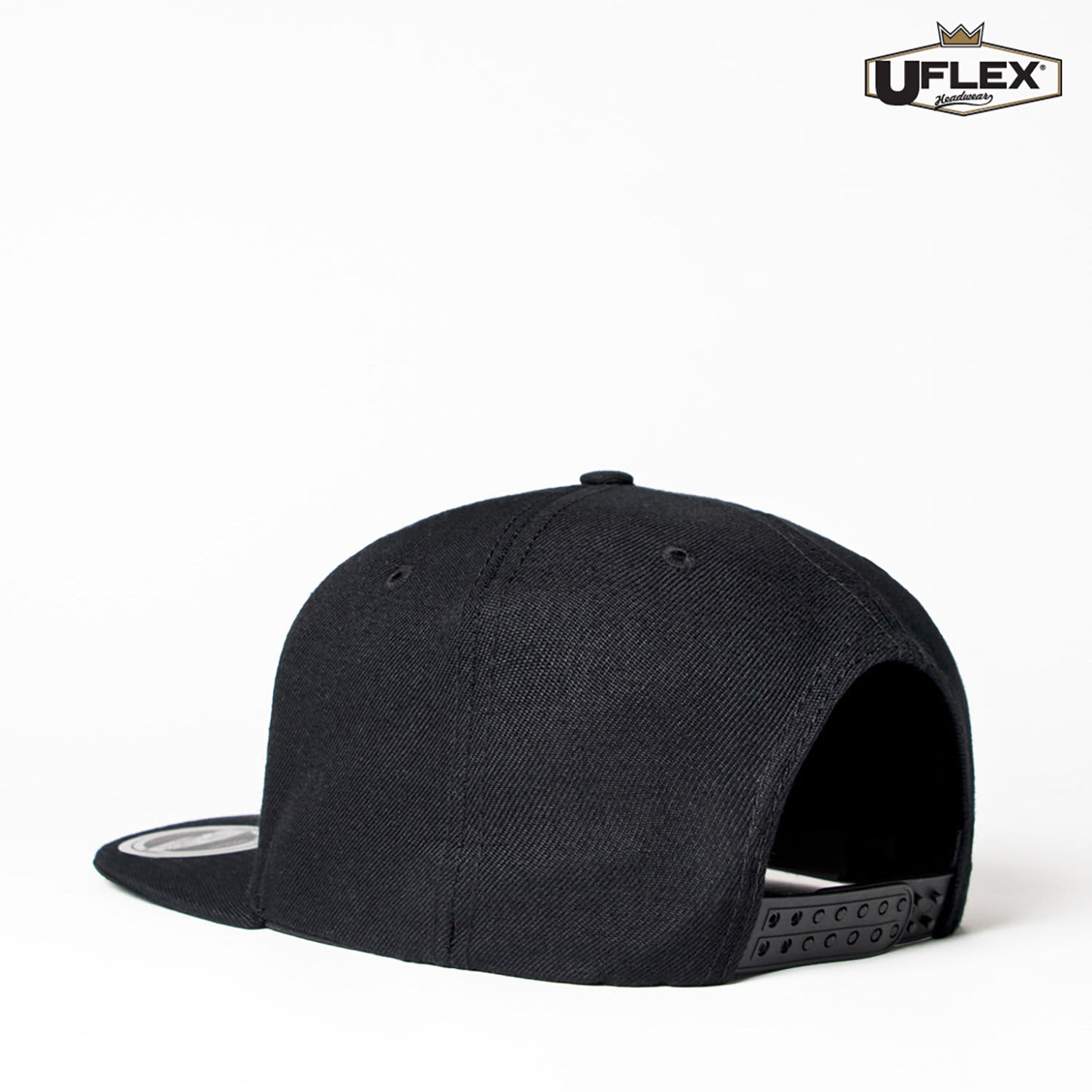 A black snapback cap featuring a branding logo on the side, viewed from the back.