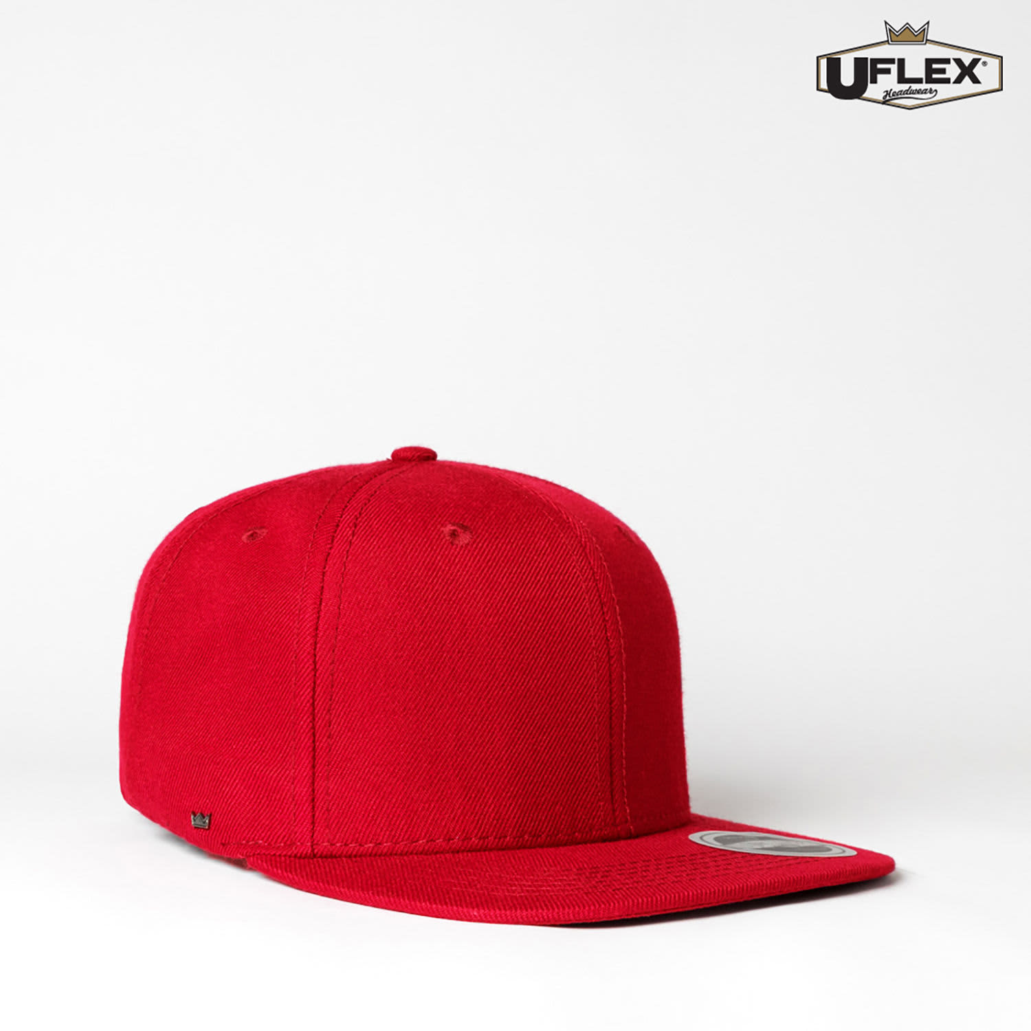 A red snapback cap featuring a flat brim and a logo on the side. The design is simple and modern.
