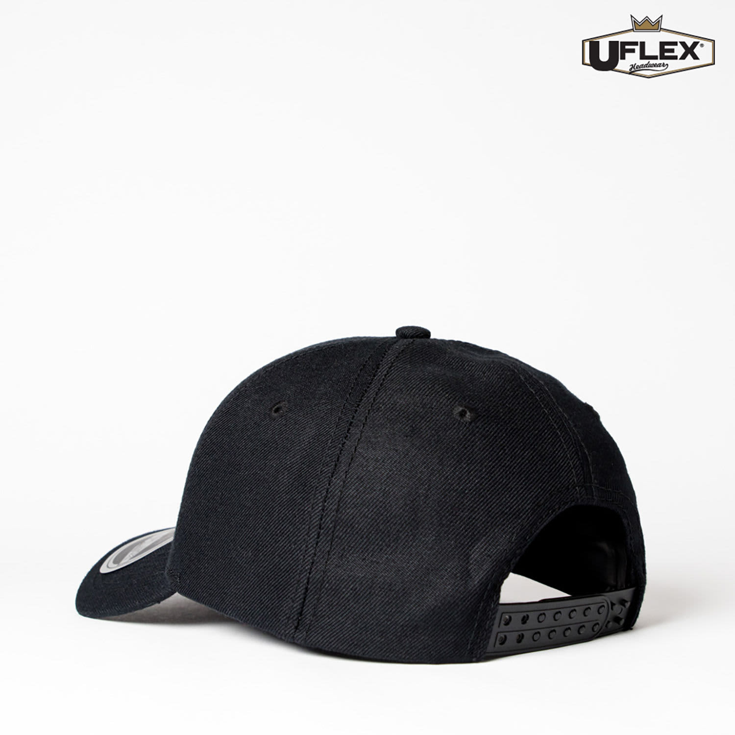 A black six-panel snapback cap featuring a logo and an adjustable strap at the back.