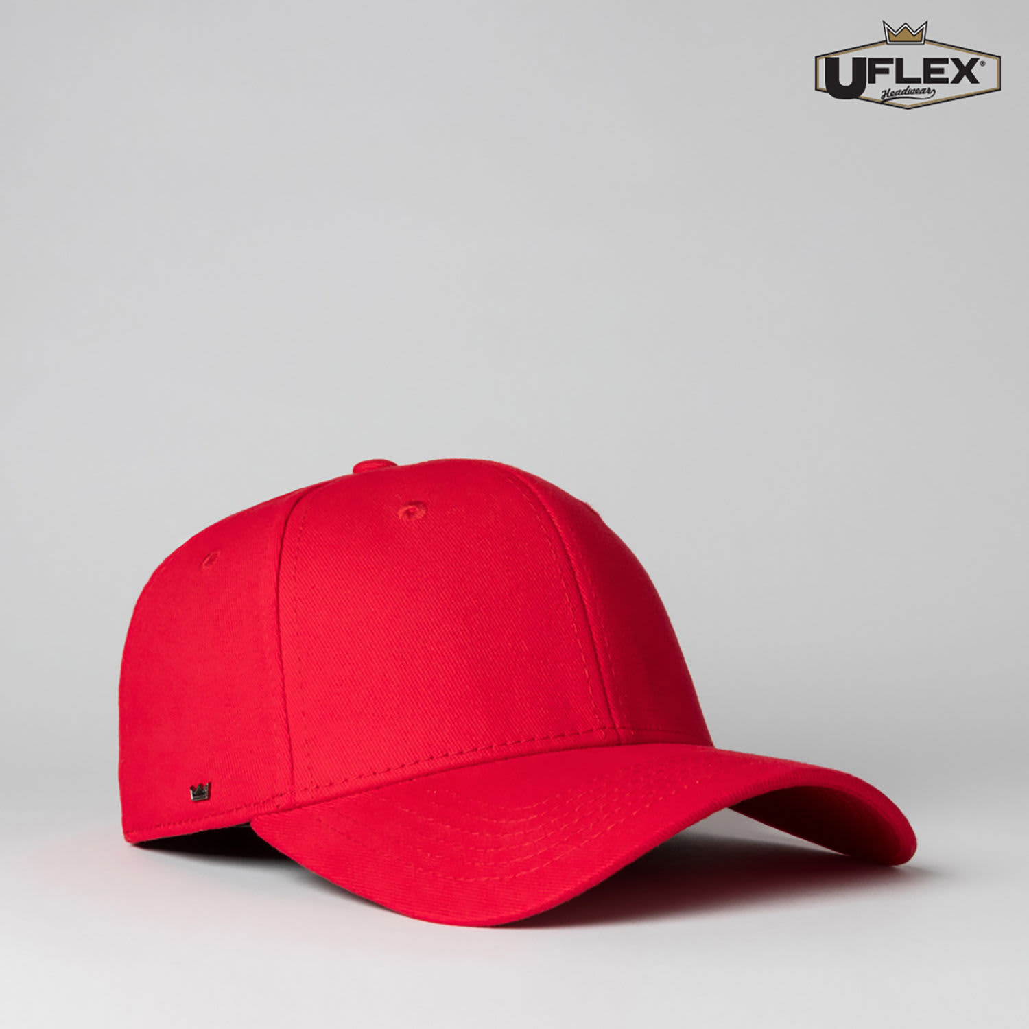 A red fitted cap with a curved brim and a small logo on the side.