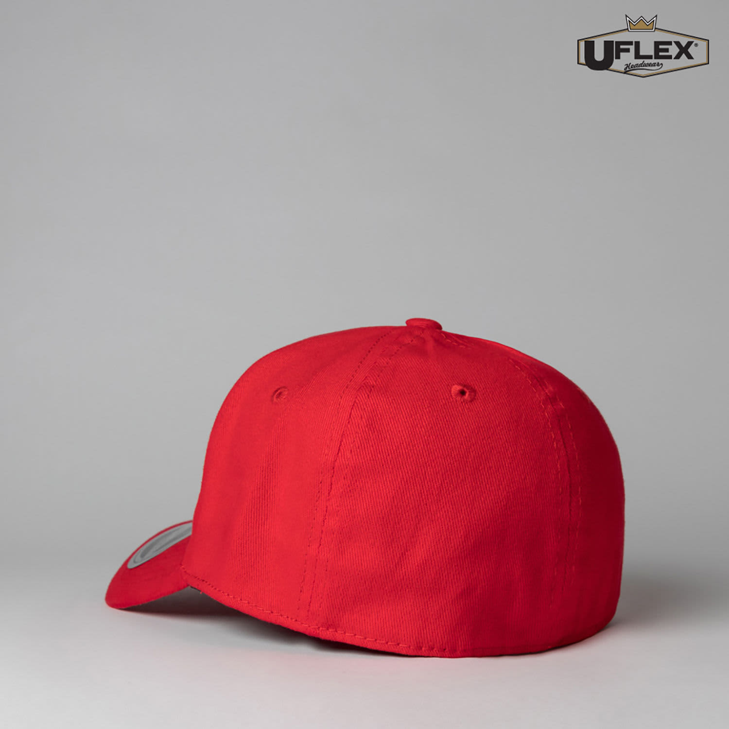 A red fitted cap with a six-panel design, featuring a branding logo on the side.