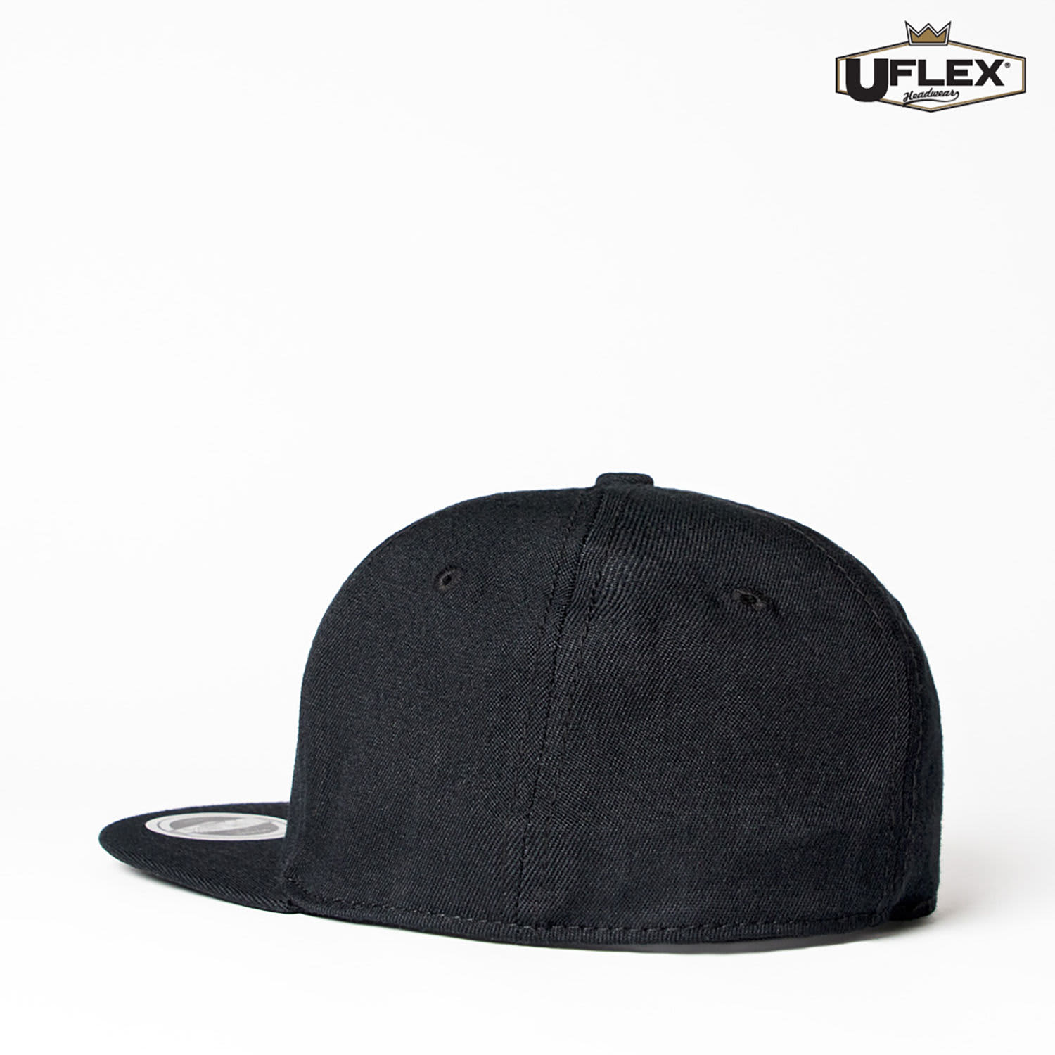 A black fitted flat peak cap featuring six panels and a logo on the side.