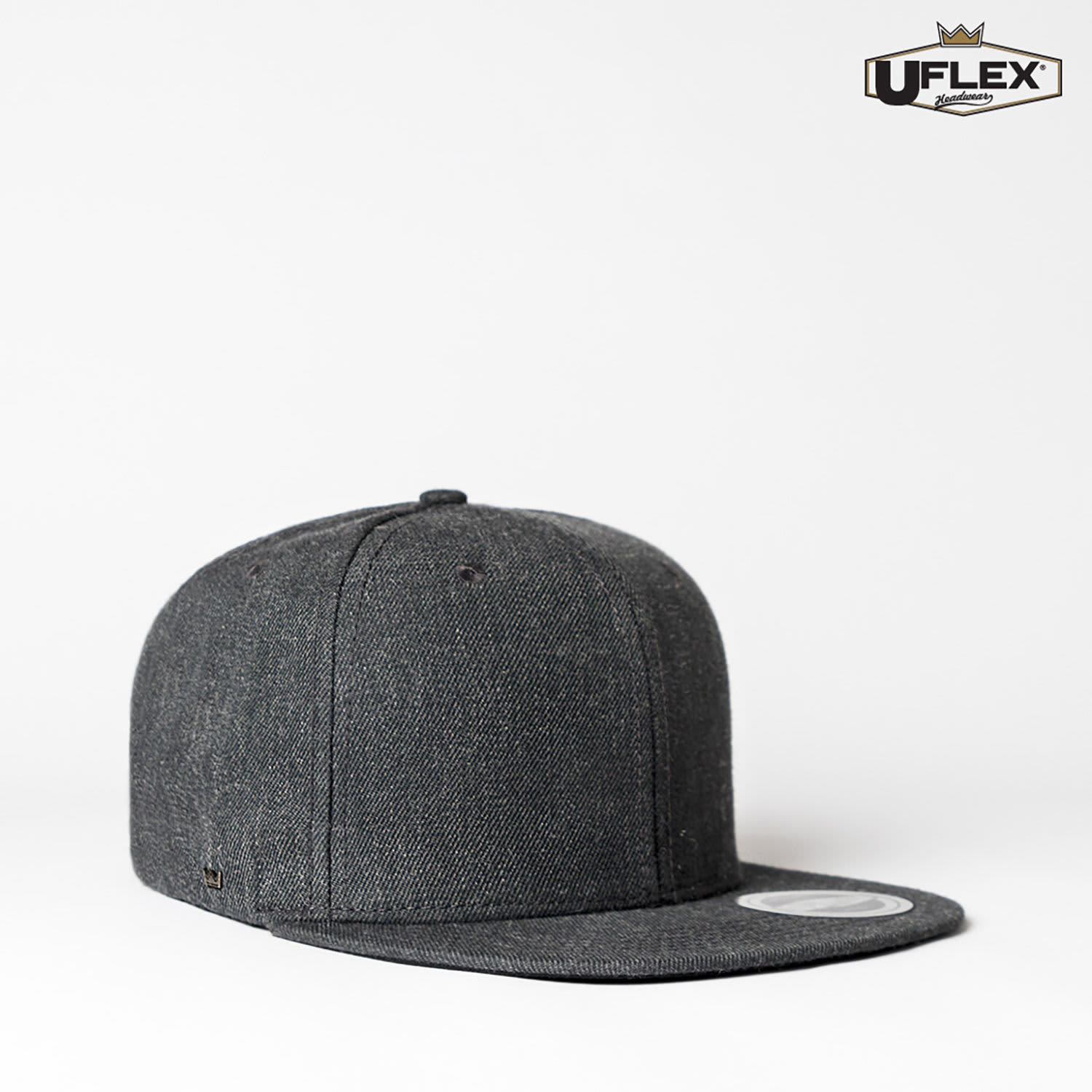 A fitted cap in dark grey with a flat peak, featuring a logo on the side.