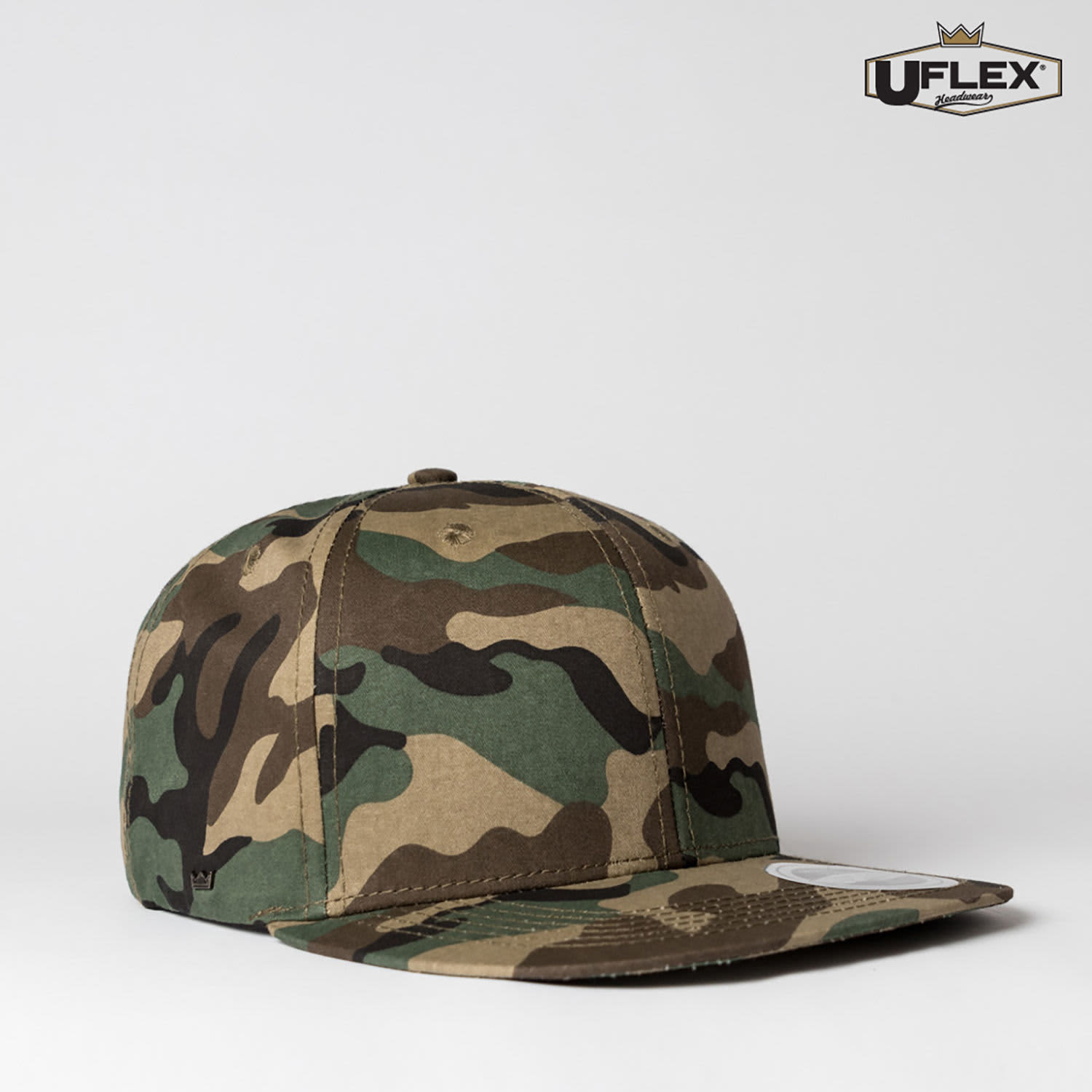 A camo-patterned snapback cap in shades of green and brown, featuring a logo on the side.