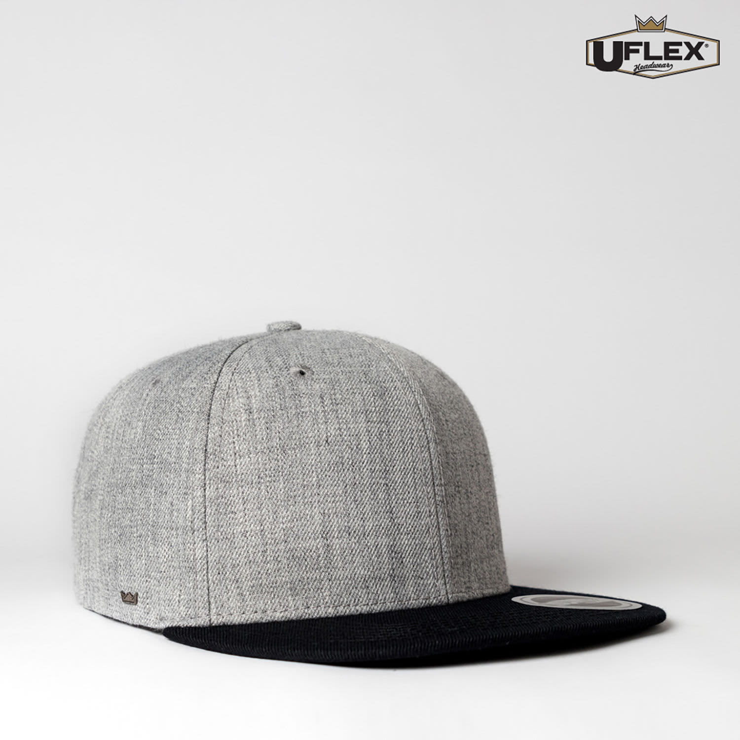 A grey cap with a black peak, featuring a logo on the side.