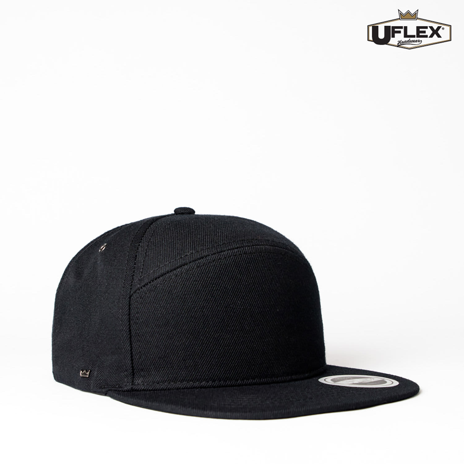 A black six-panel snapback cap with a logo, featuring a flat brim and structured design.