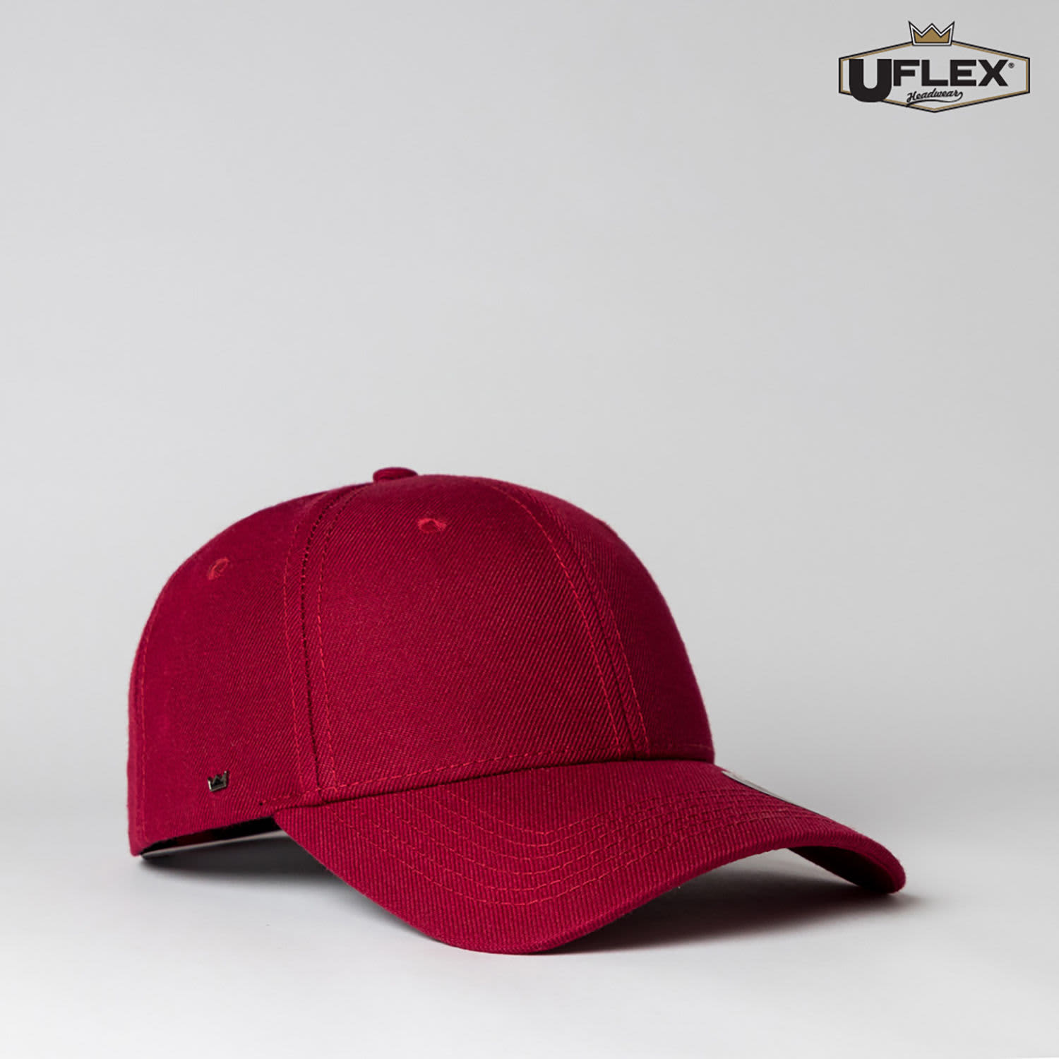 A maroon snapback cap featuring a flexible style and a logo. Suitable for various casual occasions.
