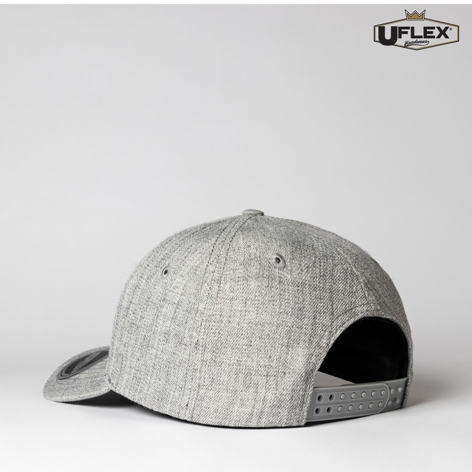 A grey six-panel snapback cap with a stylish design and a logo on the front. Features a snapback closure at the back.