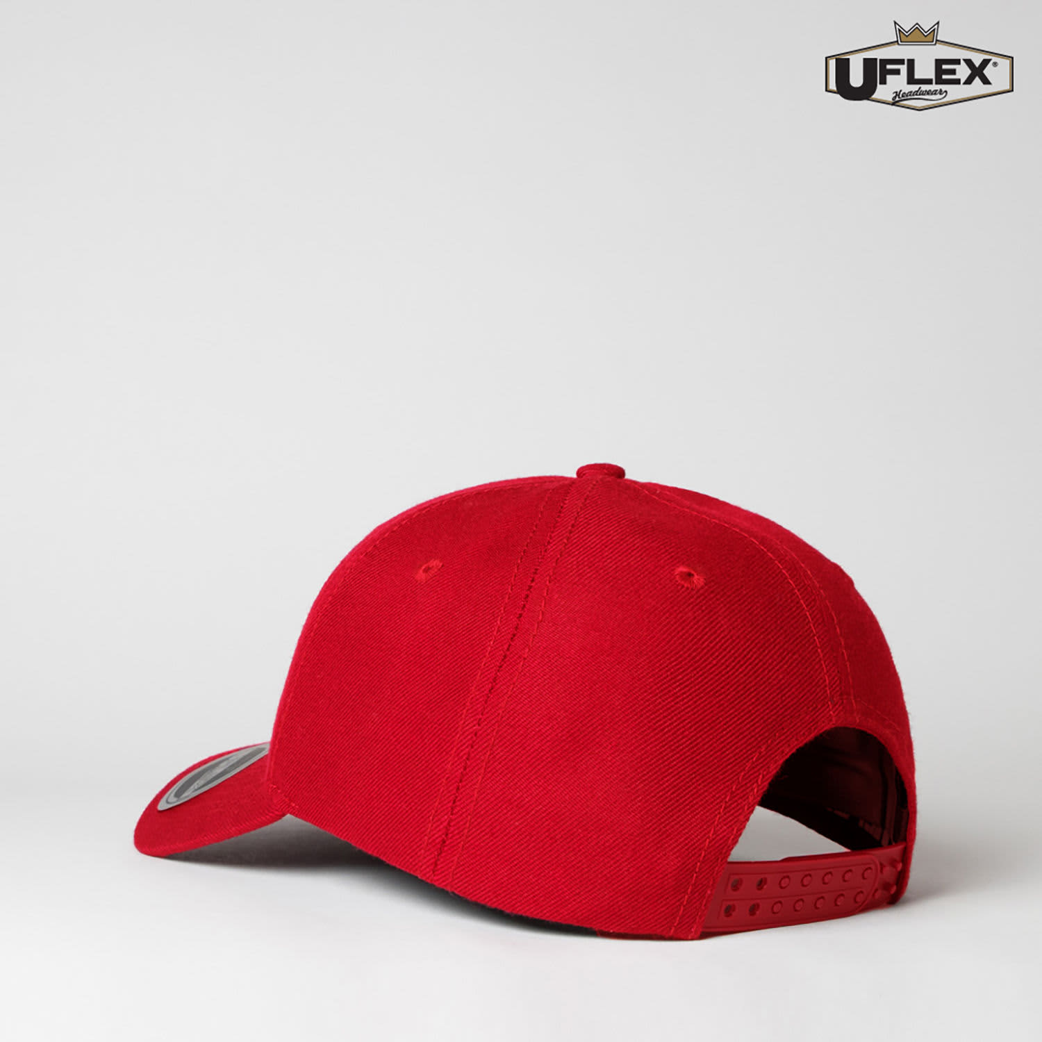 A red 6-panel snapback cap featuring a logo on the side. The back has an adjustable snap closure.