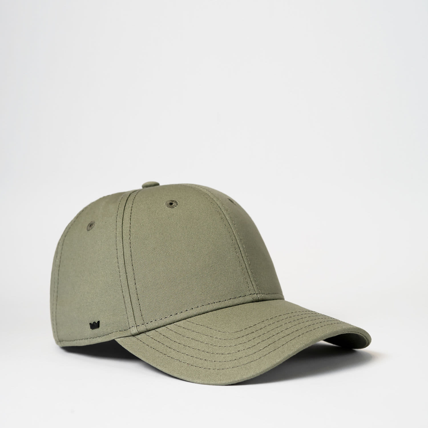 A green 6 panel baseball cap made from recycled cotton, featuring stitching detail and a small logo.