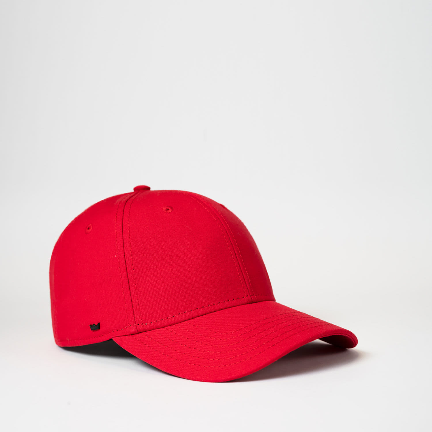 A red 6 panel recycled cotton baseball cap with a logo on the side, set against a plain background.