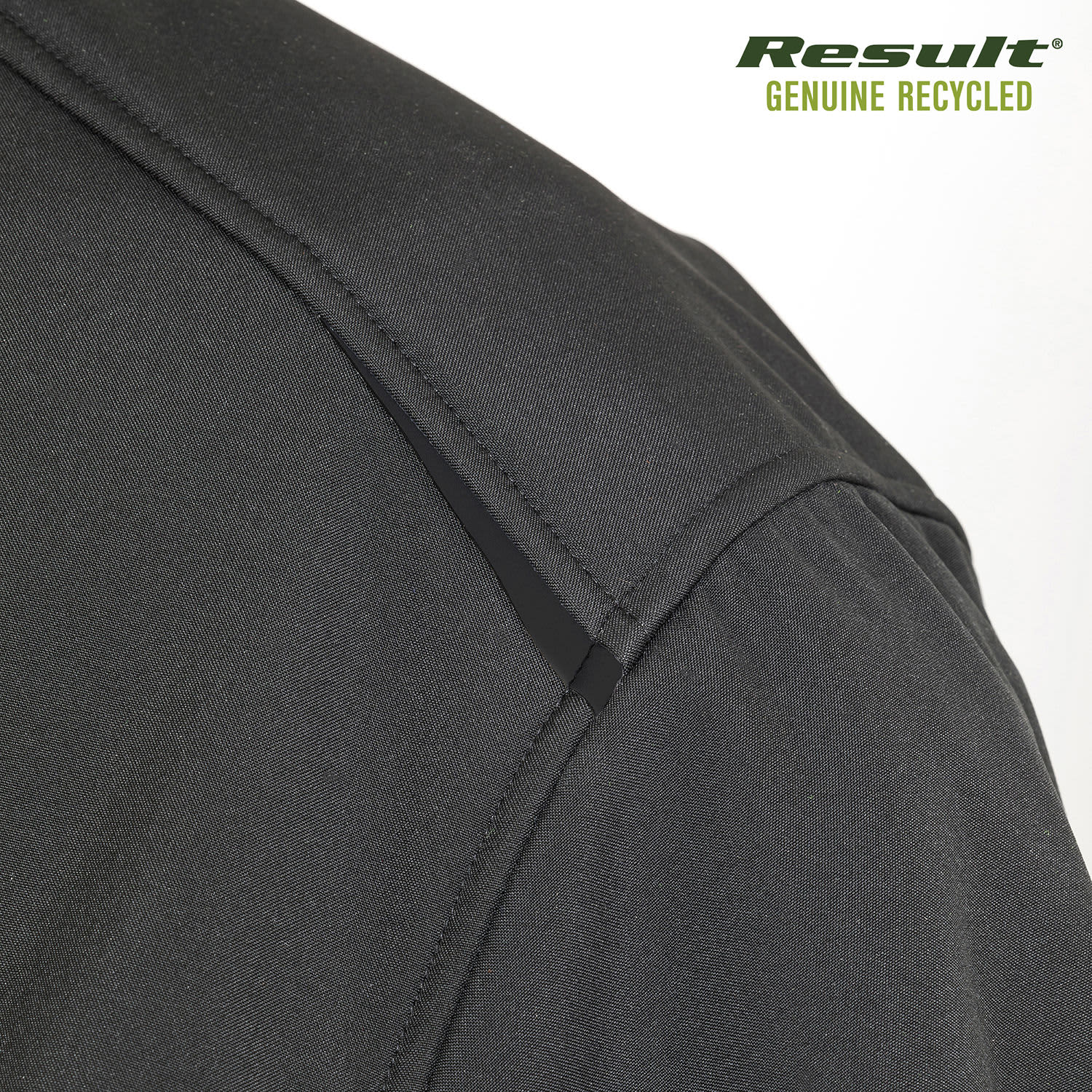A close-up of a black softshell jacket featuring a shoulder seam and a logo. The fabric appears smooth and flexible.