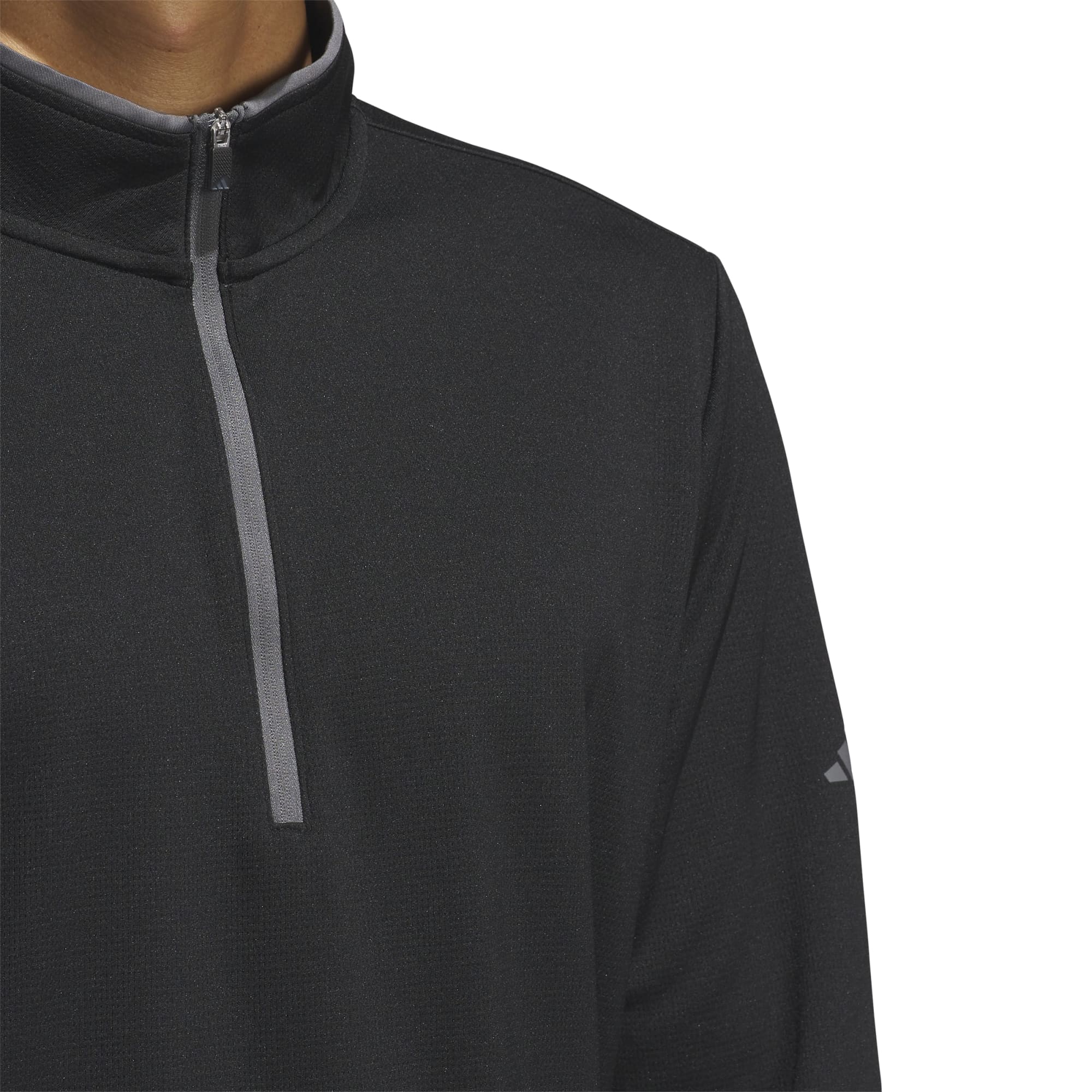A black lightweight quarter zip pullover featuring a high collar and a branding logo on the sleeve.