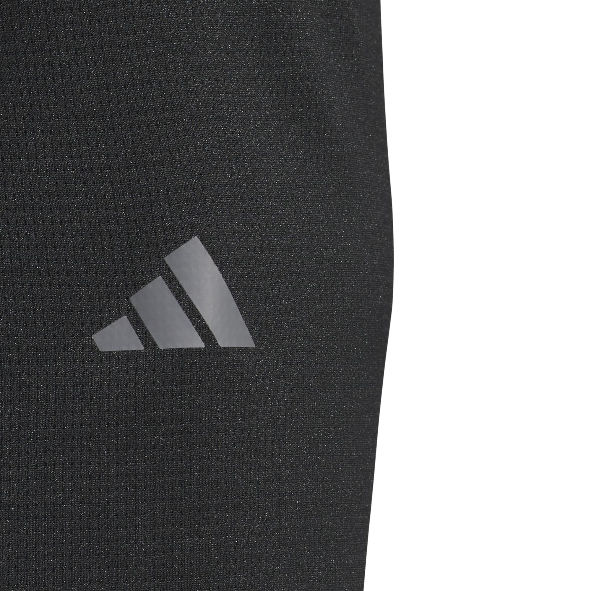 A close-up of a black pullover featuring a logo on the side. The fabric appears lightweight and textured.