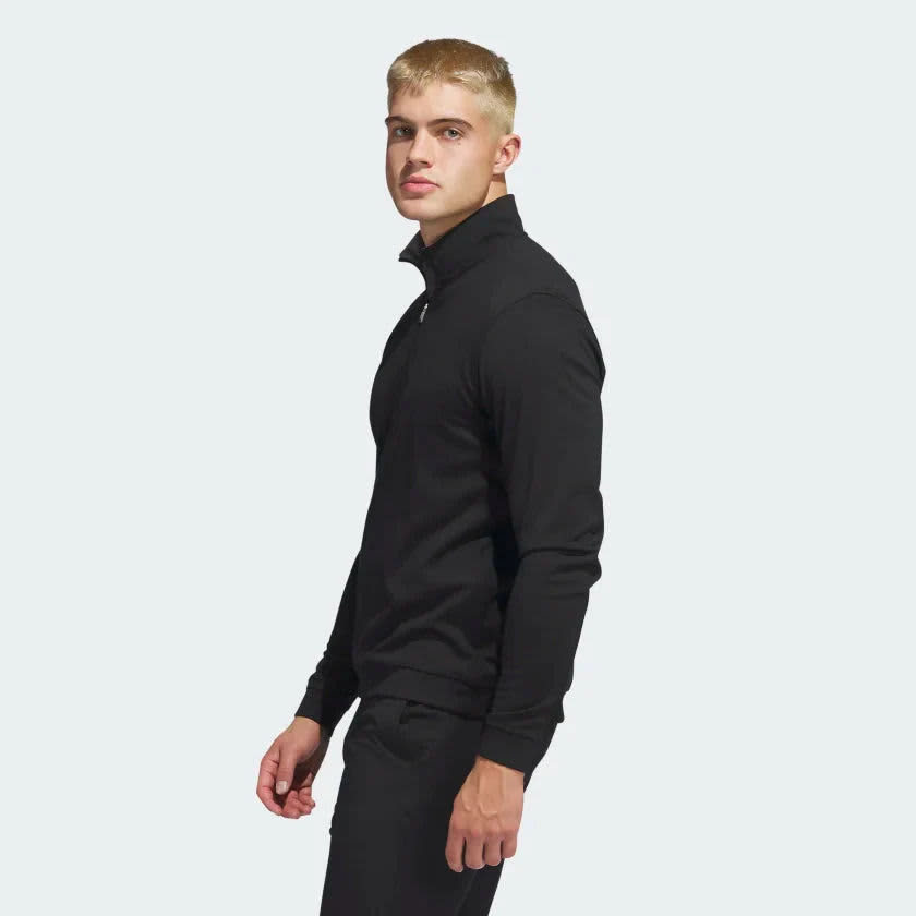 A black quarter zip pullover with a high collar, featuring long sleeves and a fitted design.