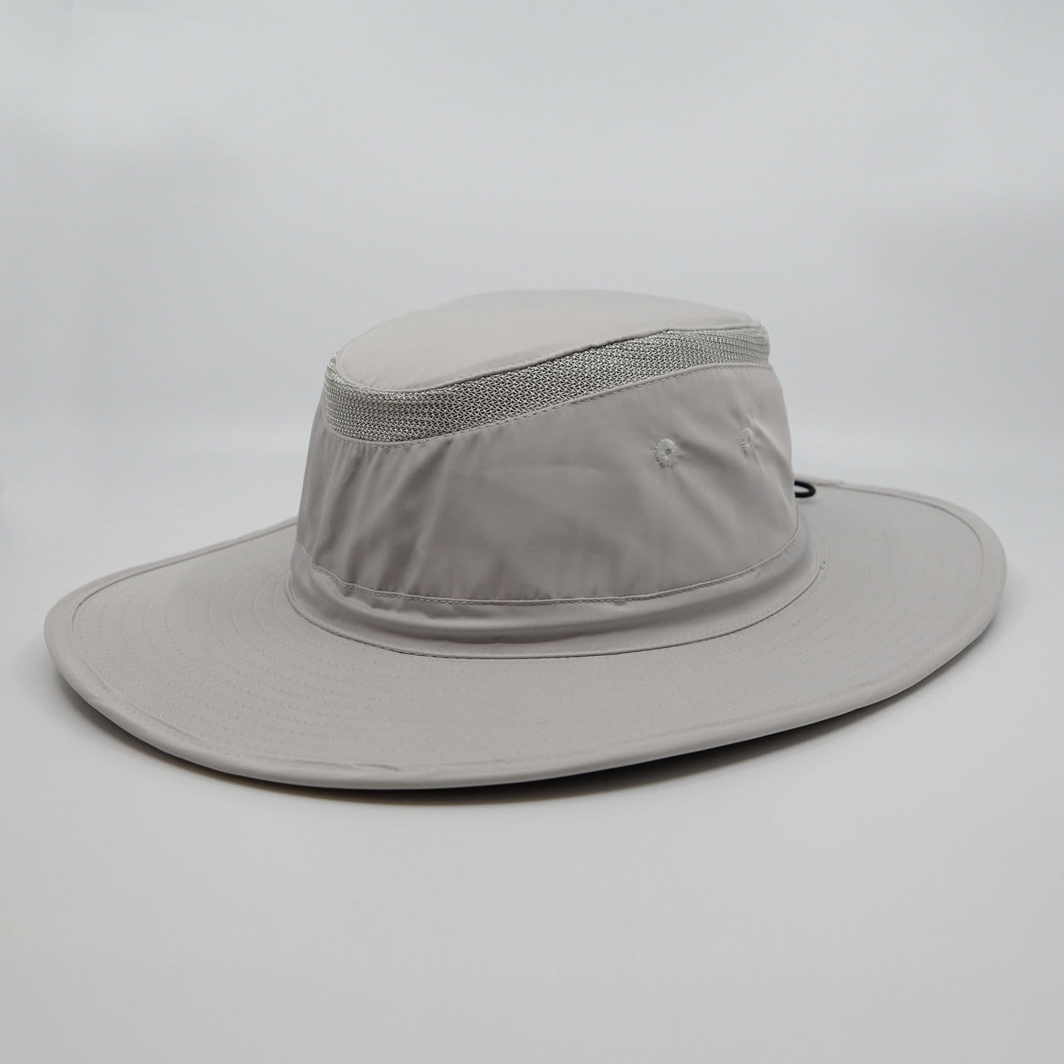 A grey brimmed sun hat with a mesh panel, featuring a logo on the side.