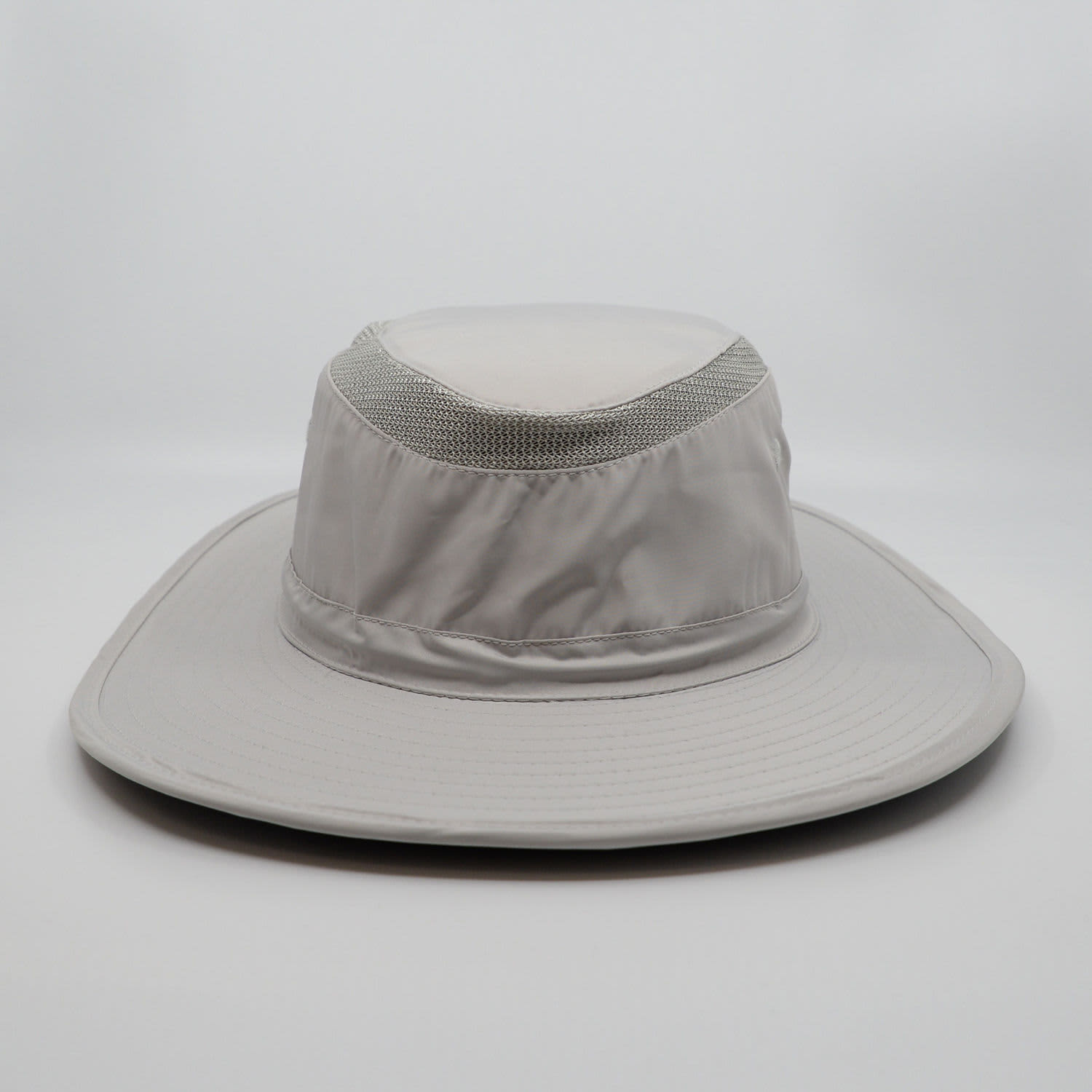 A light grey bucket hat with a wide brim and mesh detailing on the crown, featuring a logo.